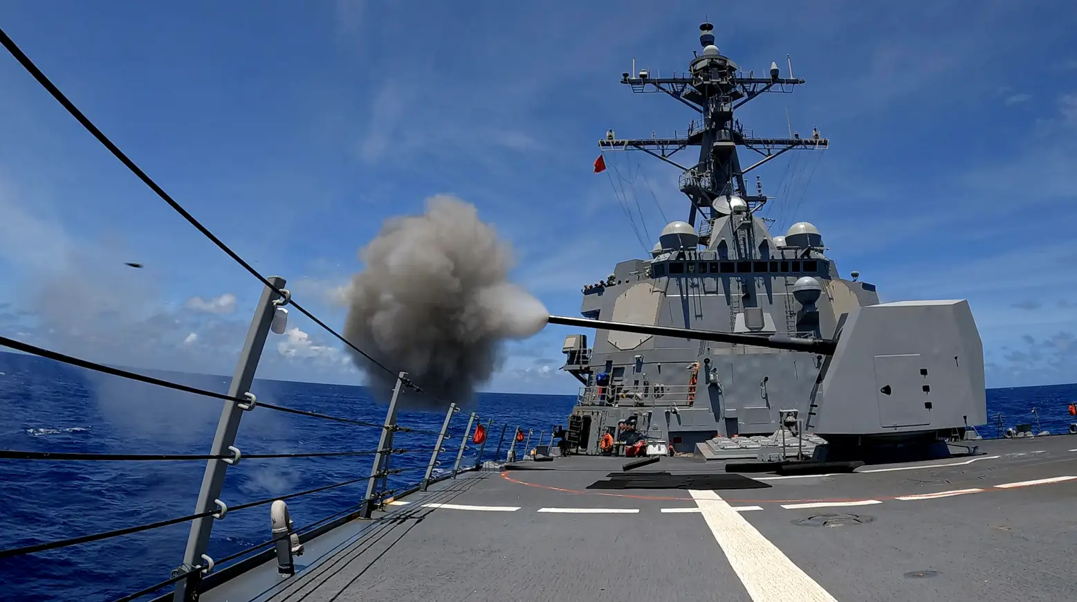 The Arleigh Burke-class guided-missile destroyer USS Dewey (DDG 105) fires the Mark 45 5-inch light-weight gun during a live-fire exercise in the Philippine Sea, Aug. 21, 2024.