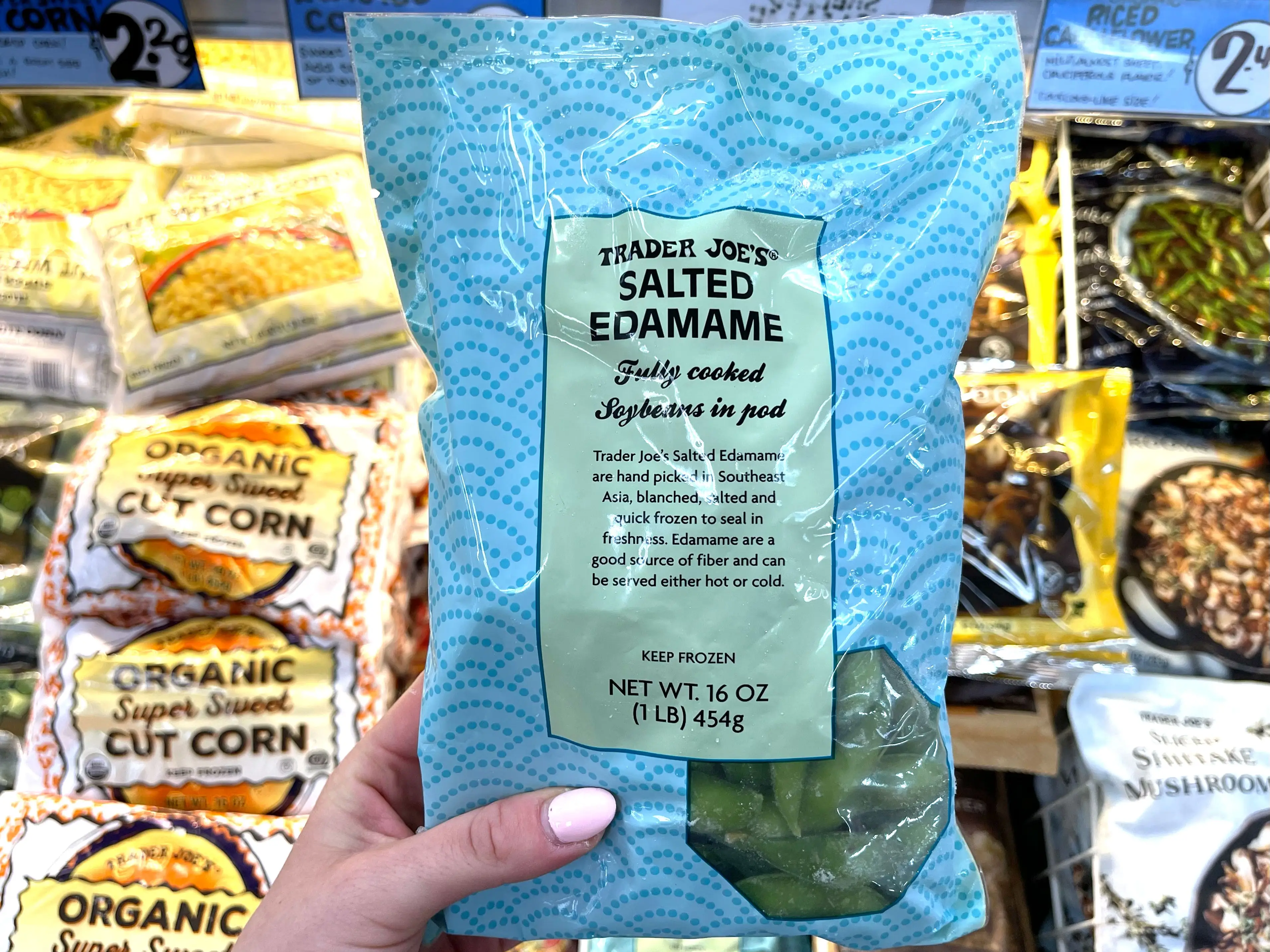 Serena holds a bag of Trader Joe's frozen salted edamame.