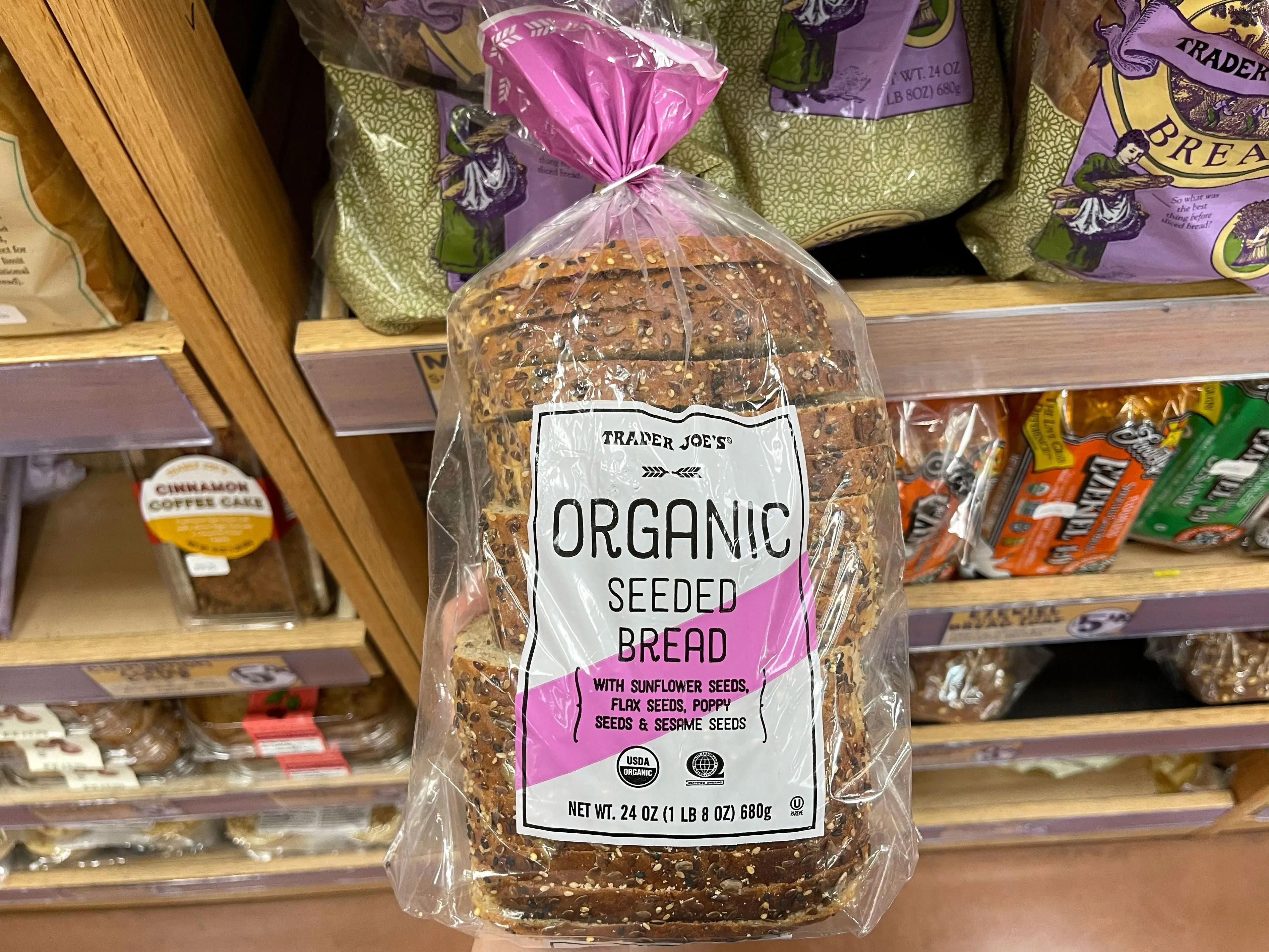 Serena holds a loaf of Trader Joe's organic seeded bread.