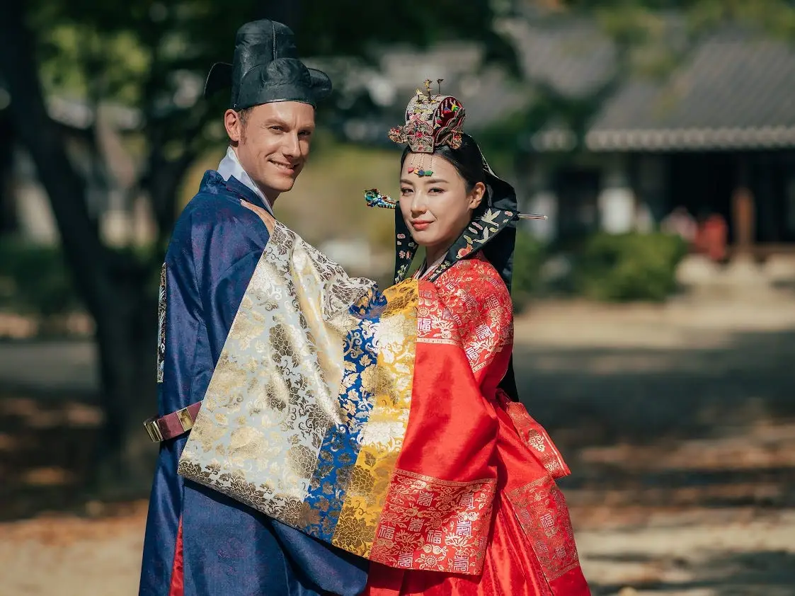 Couple dressed up for a traditional Korean wedding.