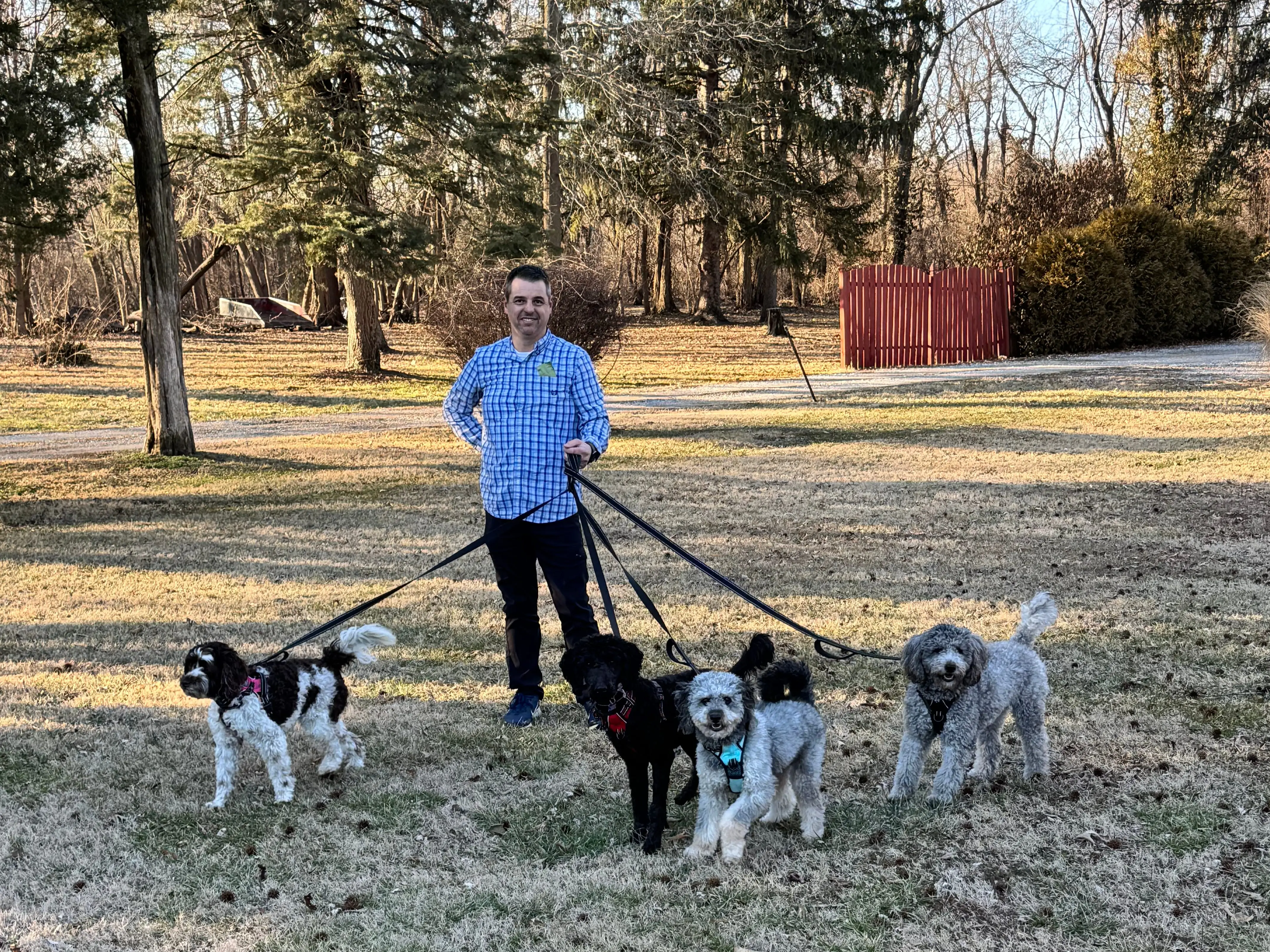 The author's husband poses with their four dogs.