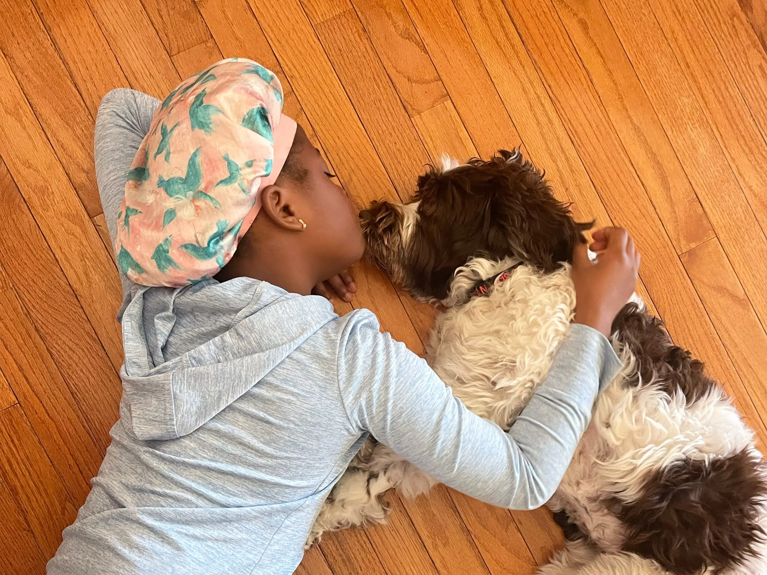 One of the author's children snuggles with one of their dogs.