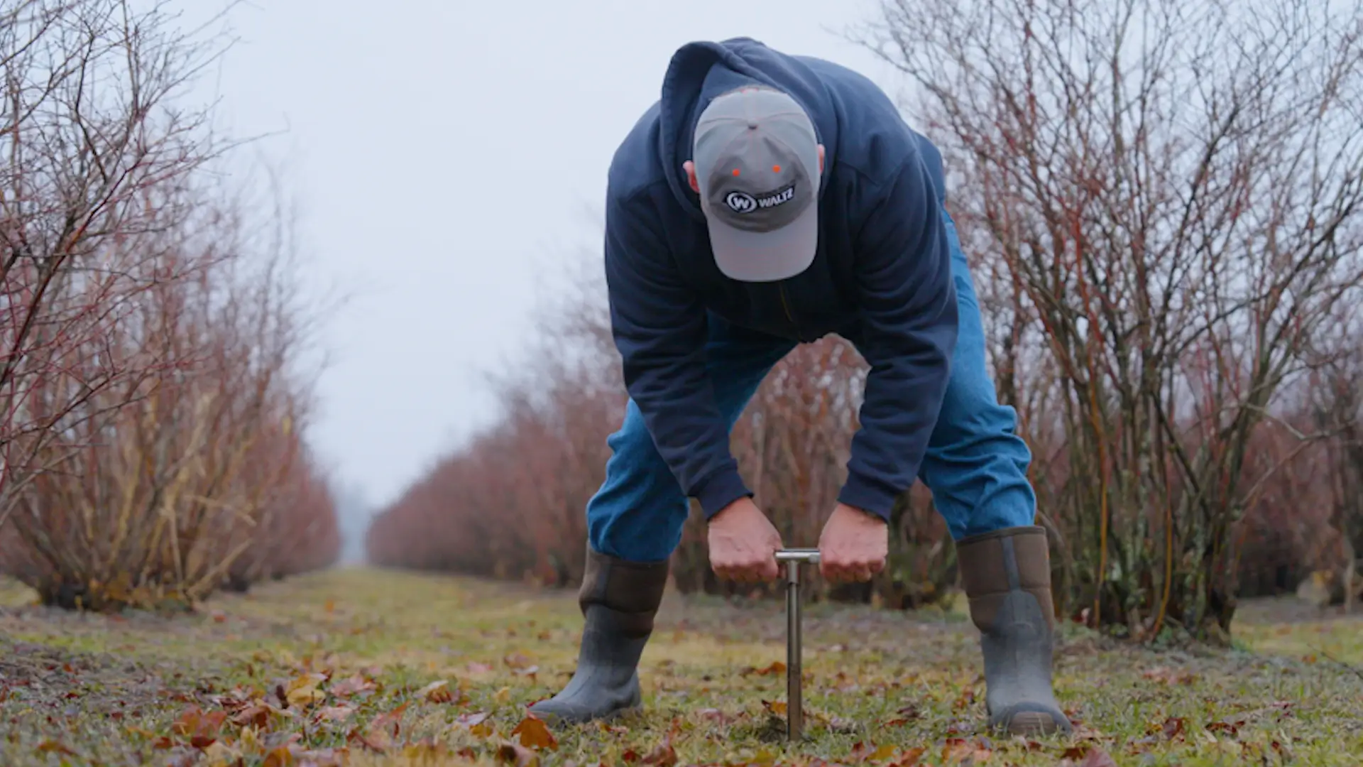 Harry checking the soil on his Pennsylvania farm