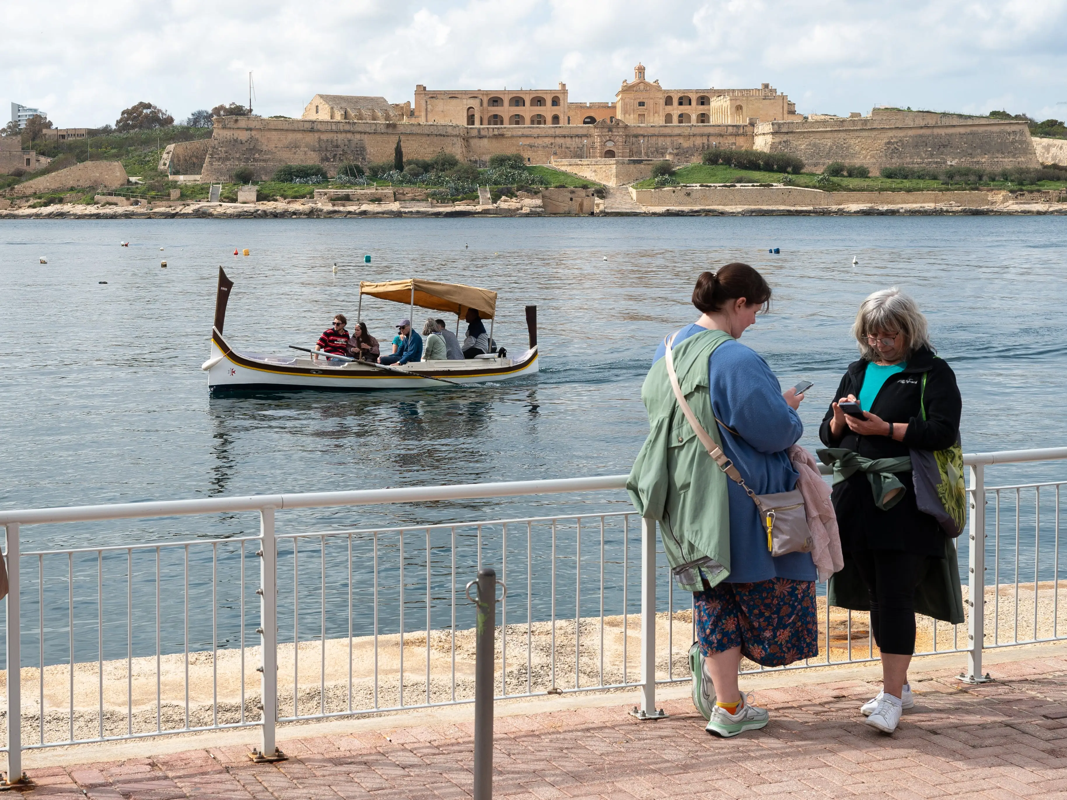 People ride on water taxi boat in Valletta, Malta.