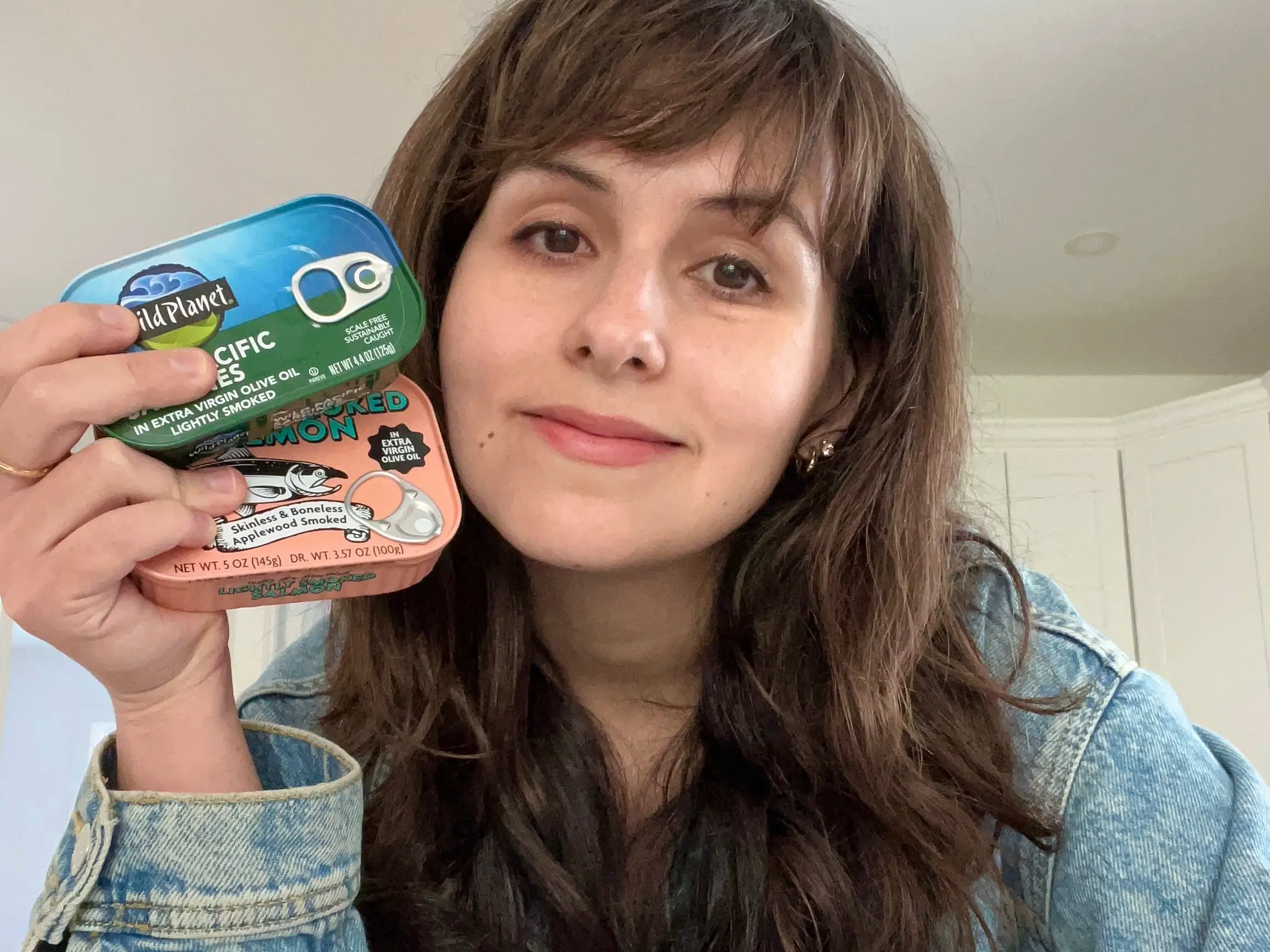 Woman holding tinned fish