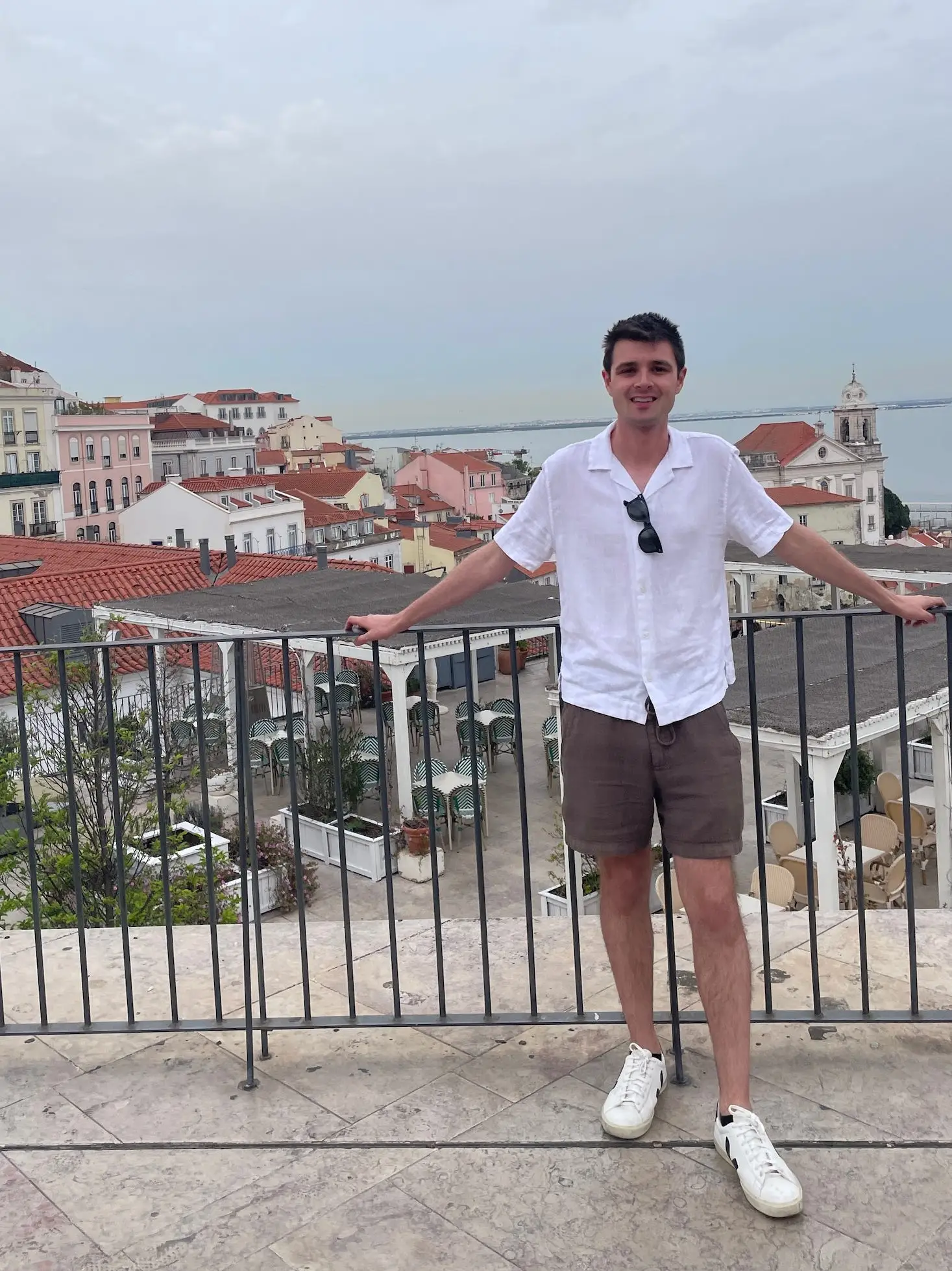 A man with the Lisbon skyline behind him.
