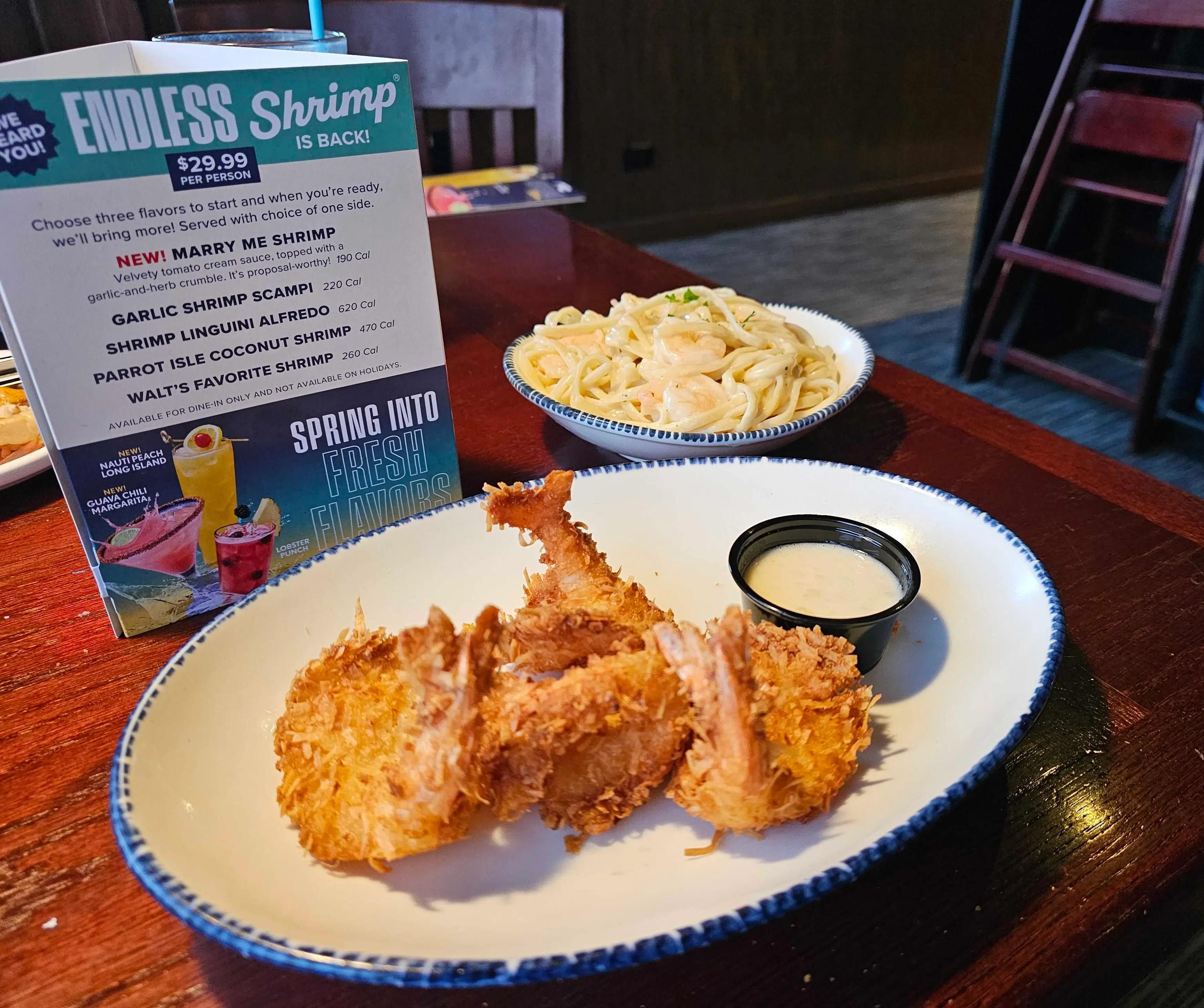 Two plates of Endless Shrimp options in front of a Red Lobster diner