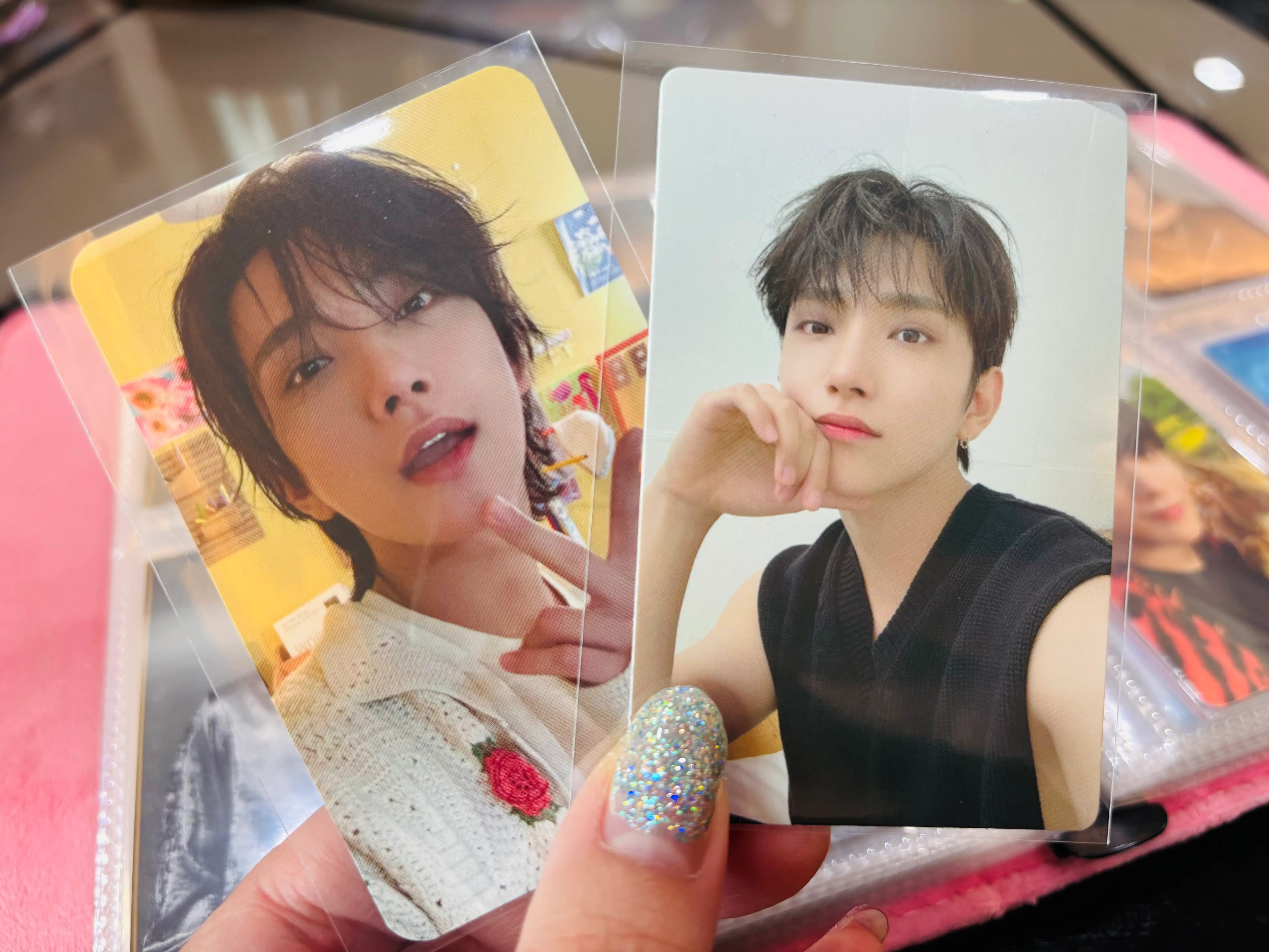 A close up of two of my favorite K-pop photocards