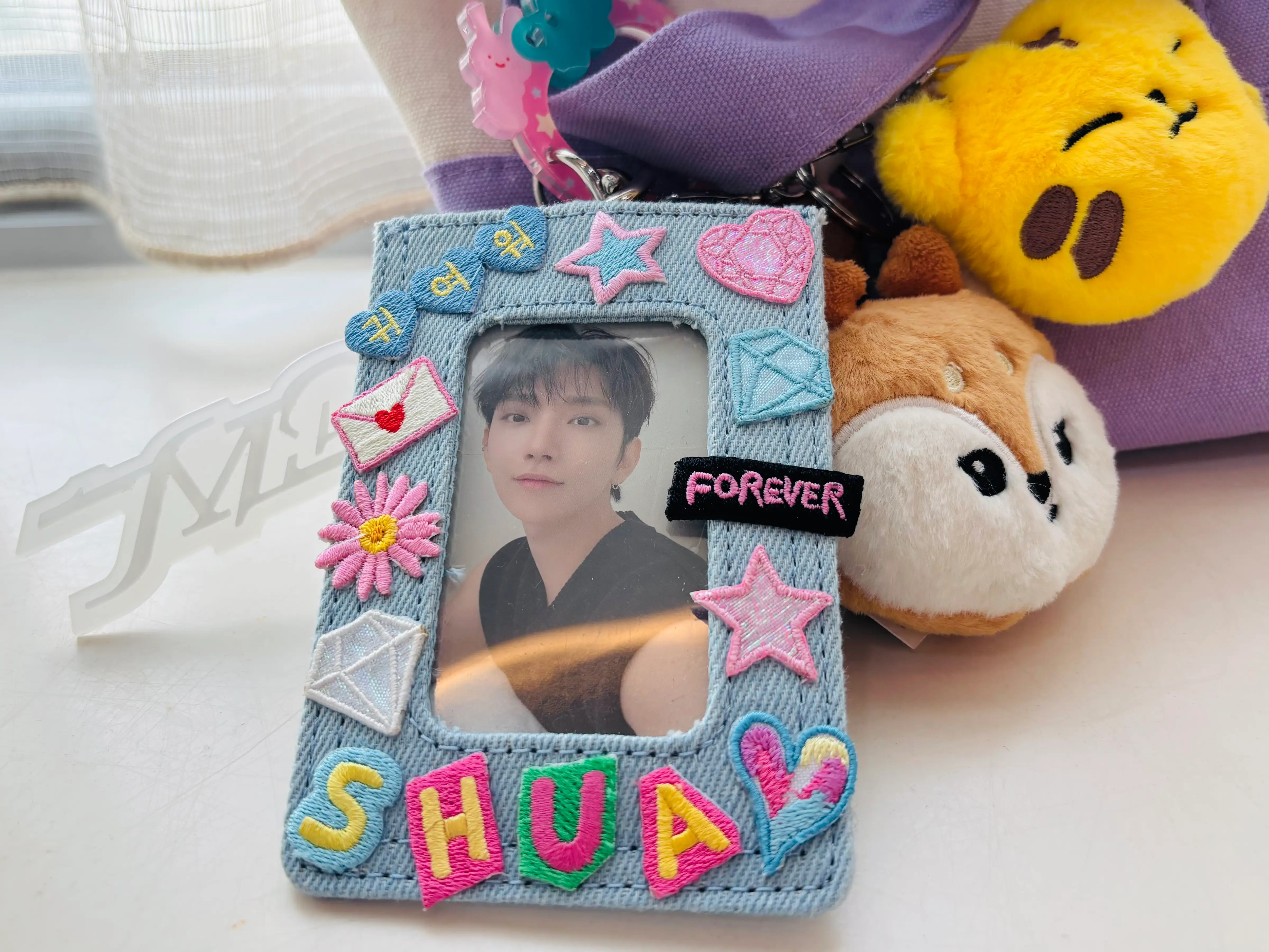 A close up of my cards in a denim photocard holder.