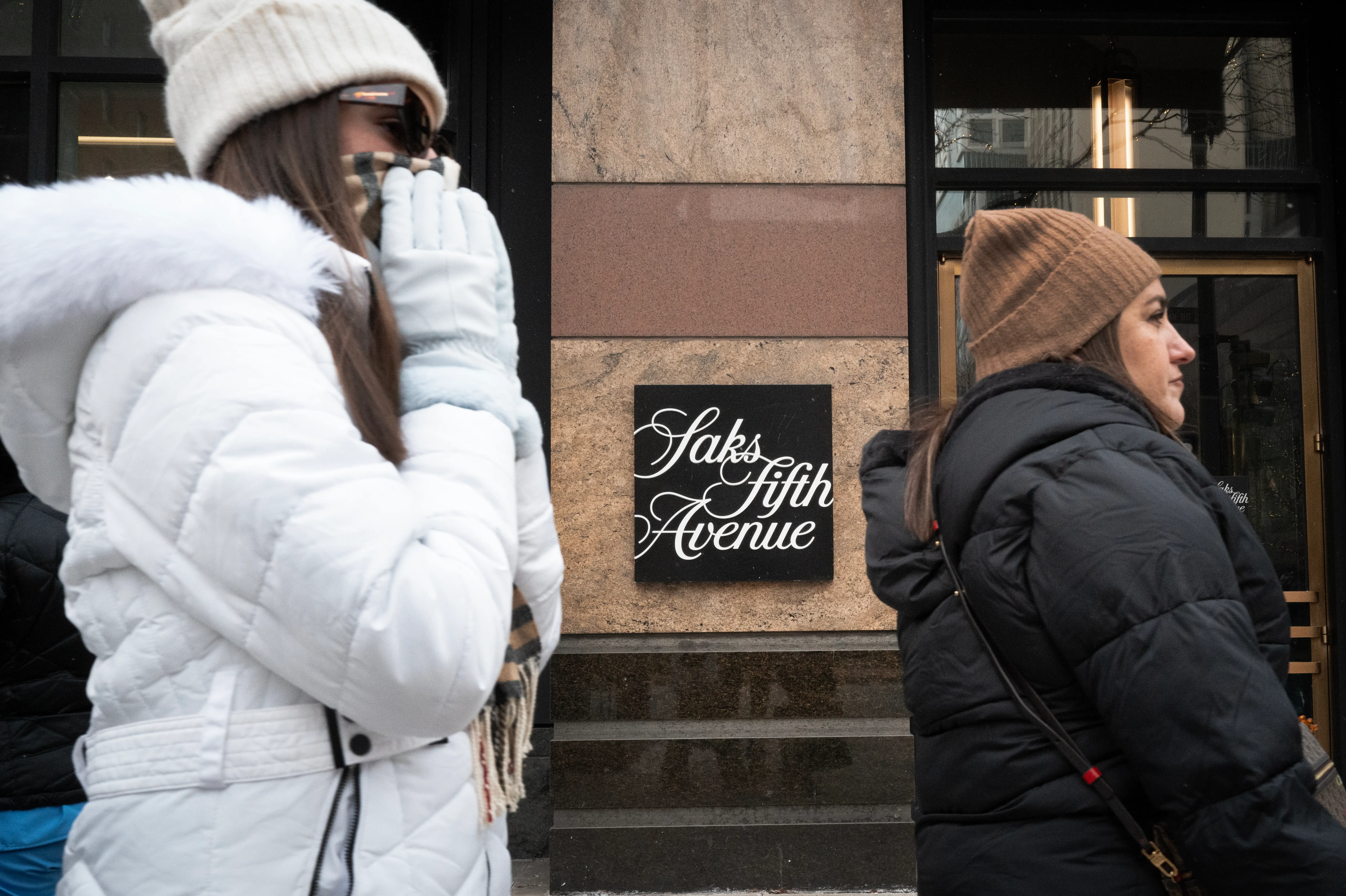 Pedestrians walk past a Saks Fifth Avenue store on December 30, 2025 in Chicago, Illinois.