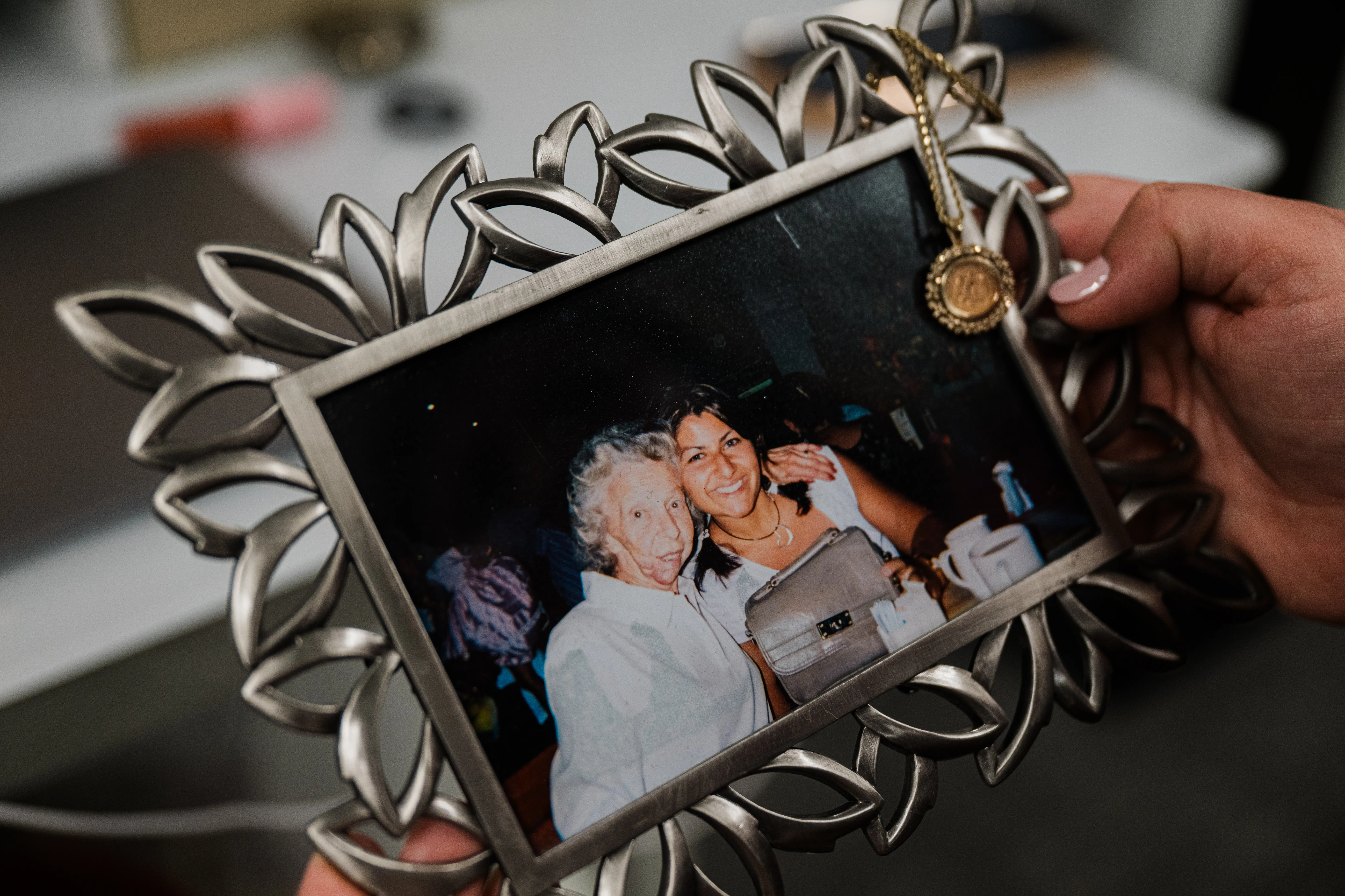 Jasmine Bhatti holds a framed photo of her and her grandmother.