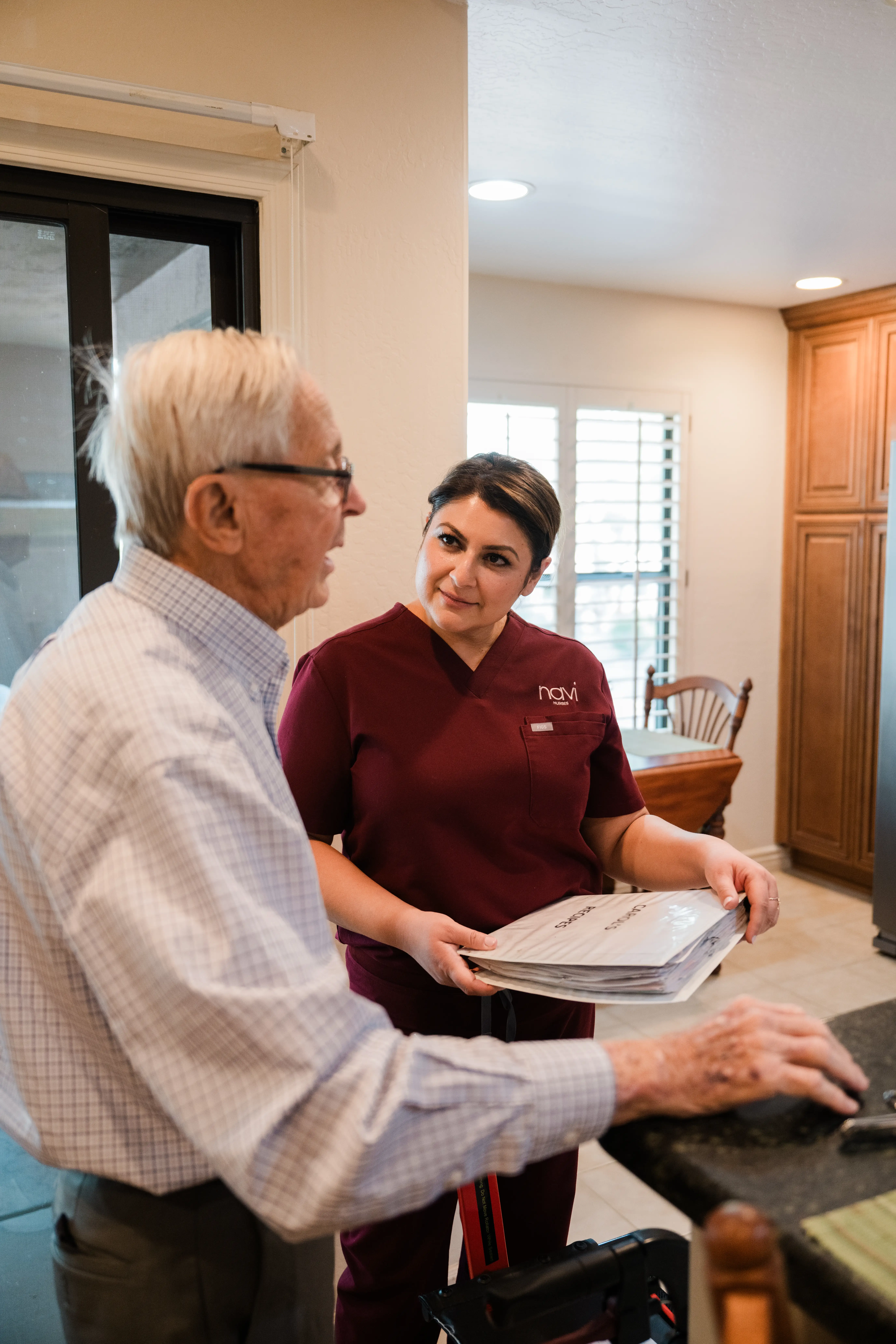 Jasmine talks with a patient in his house.