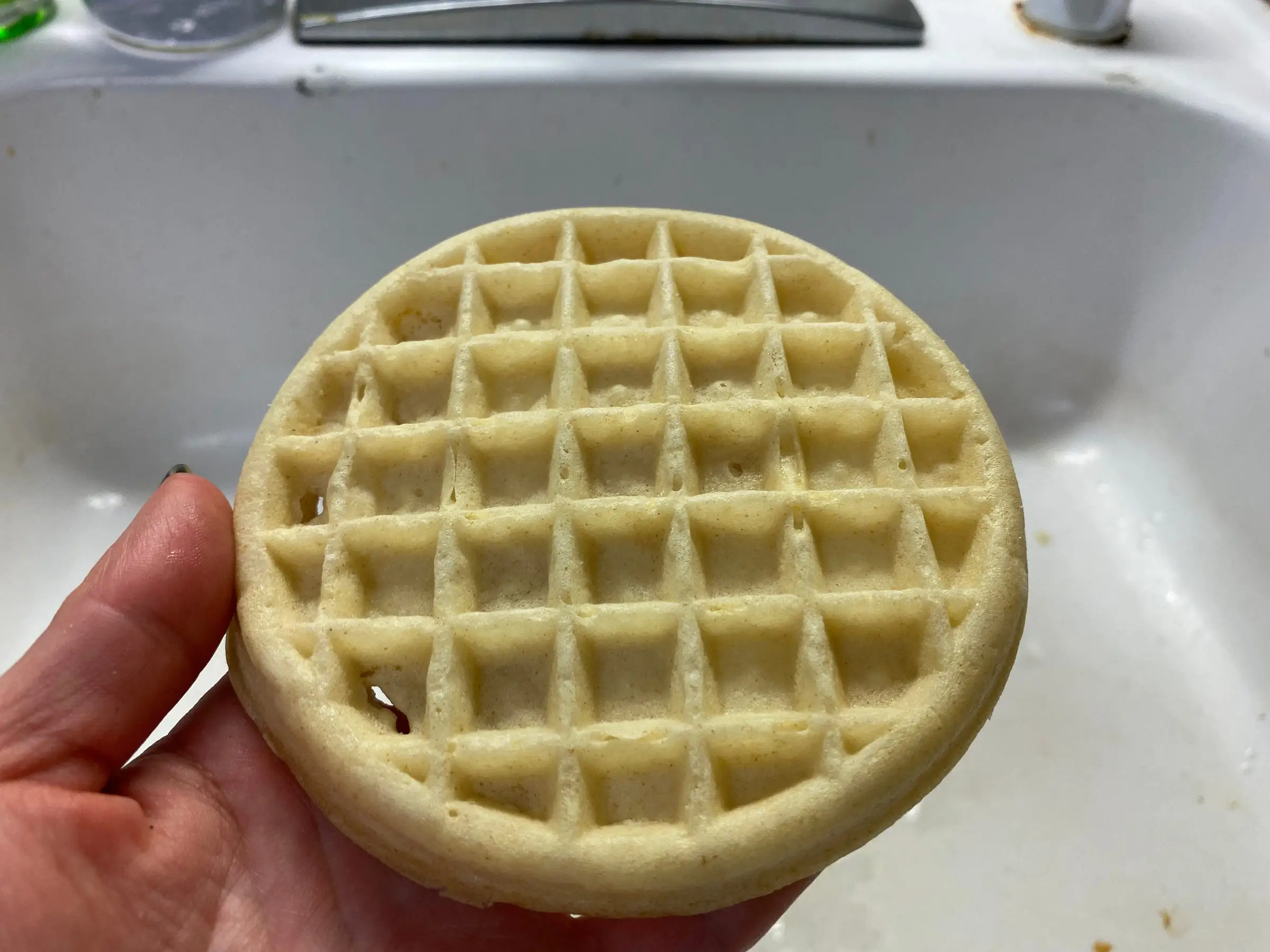 hand holding cooked frozen waffle