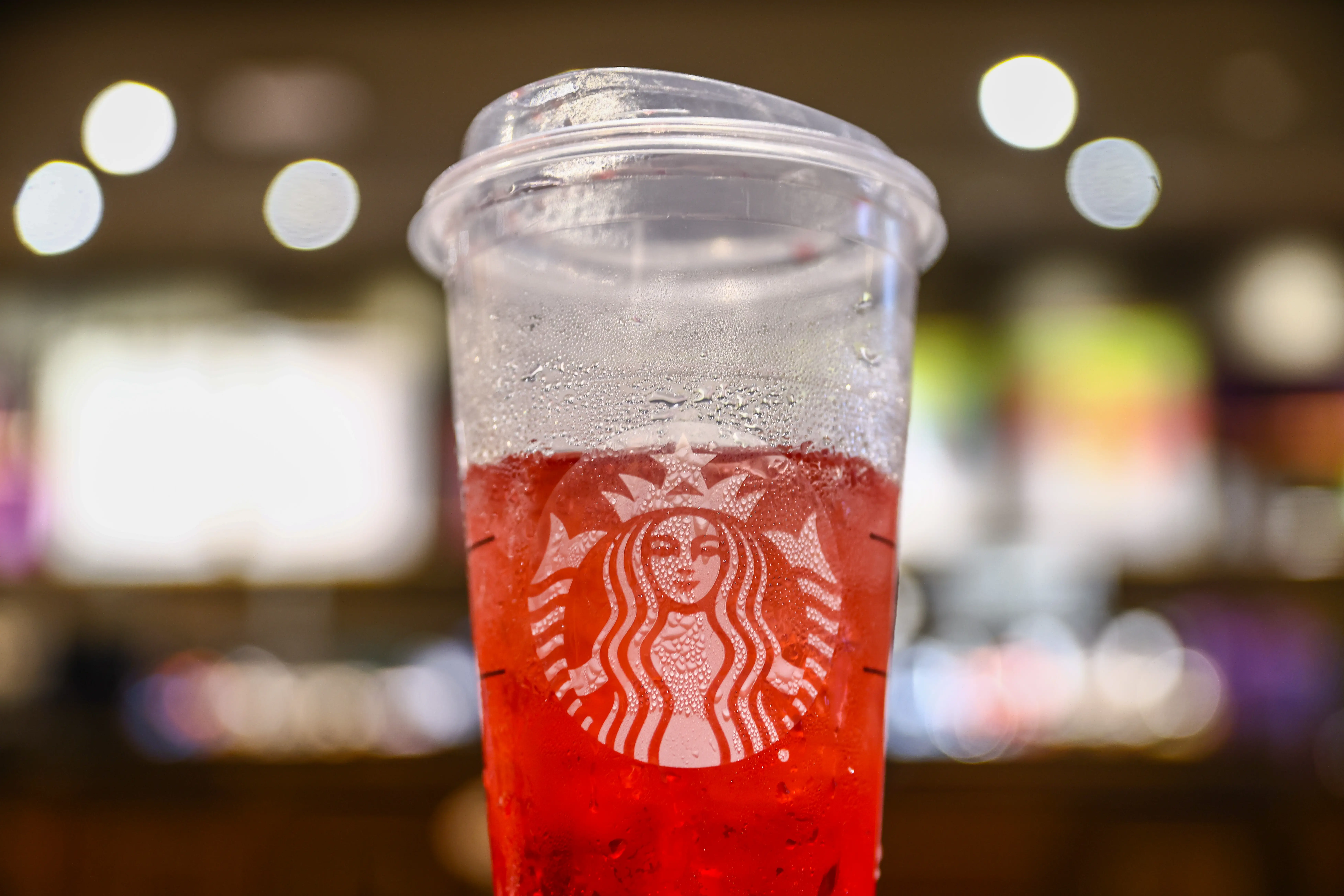 A Starbucks cup with a Refresher drink inside.