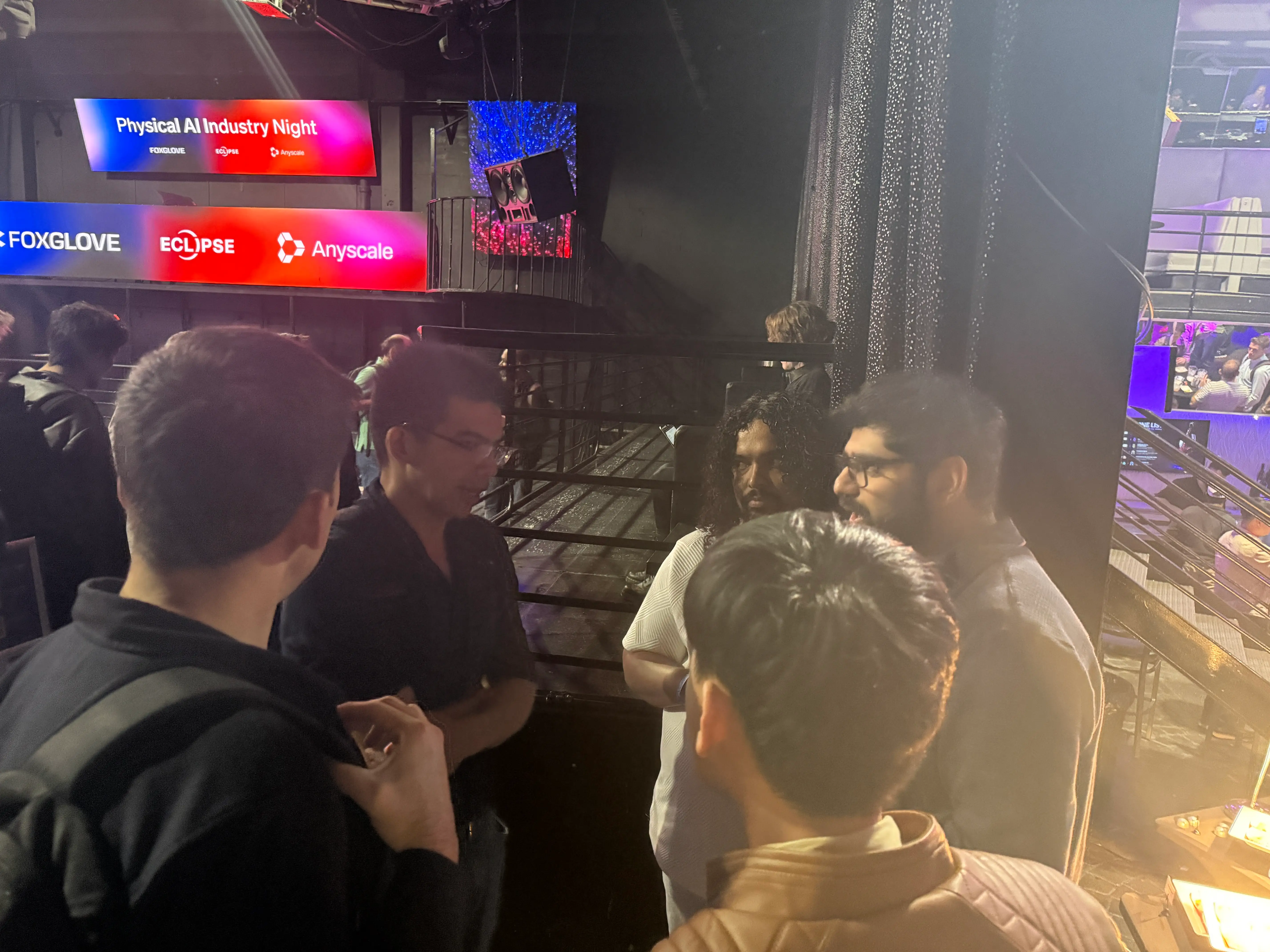 Ruijie He of Mind Robotics surrounded by younger startup founders and employees.