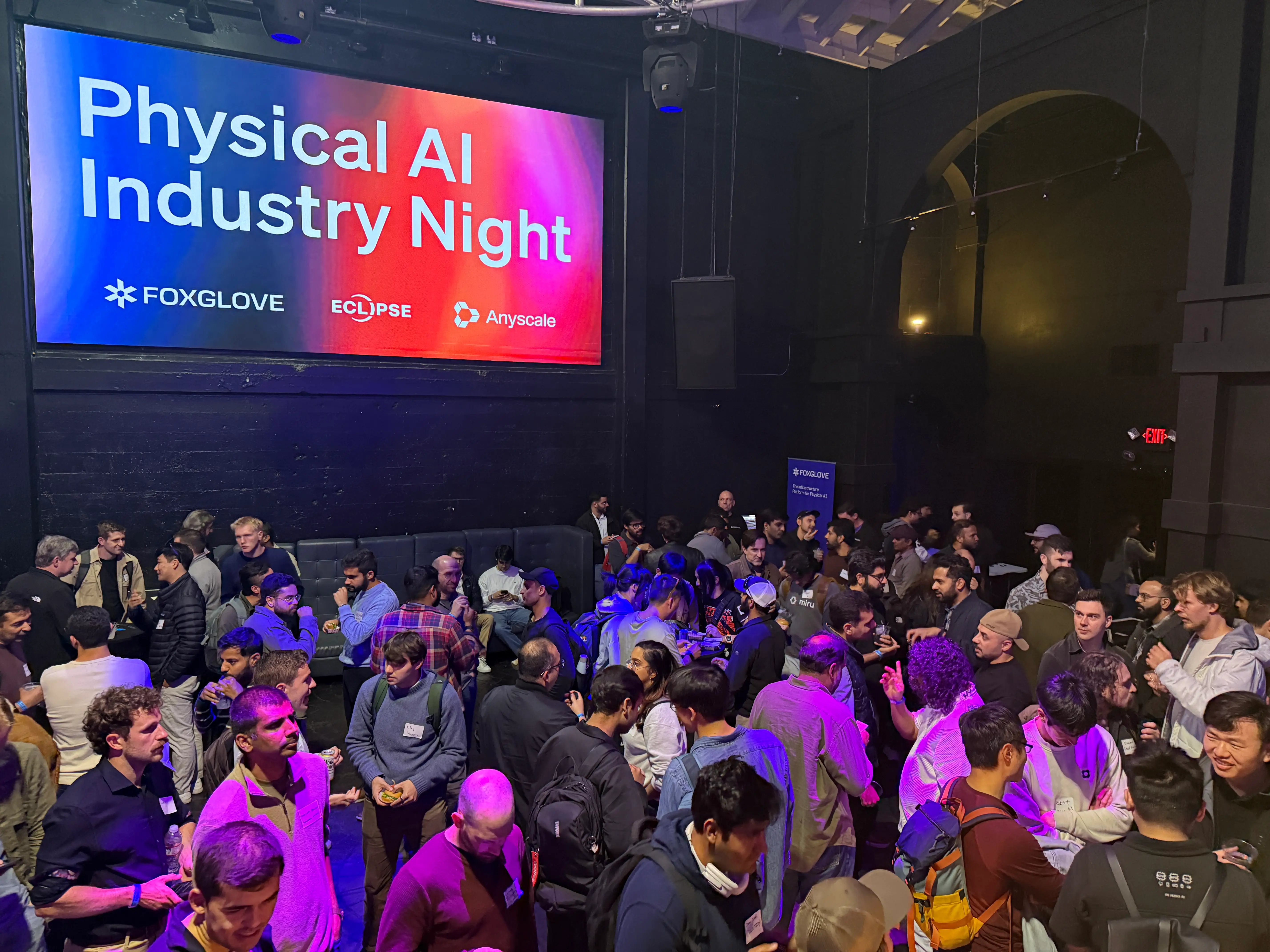 A crowd of people inside a venue.