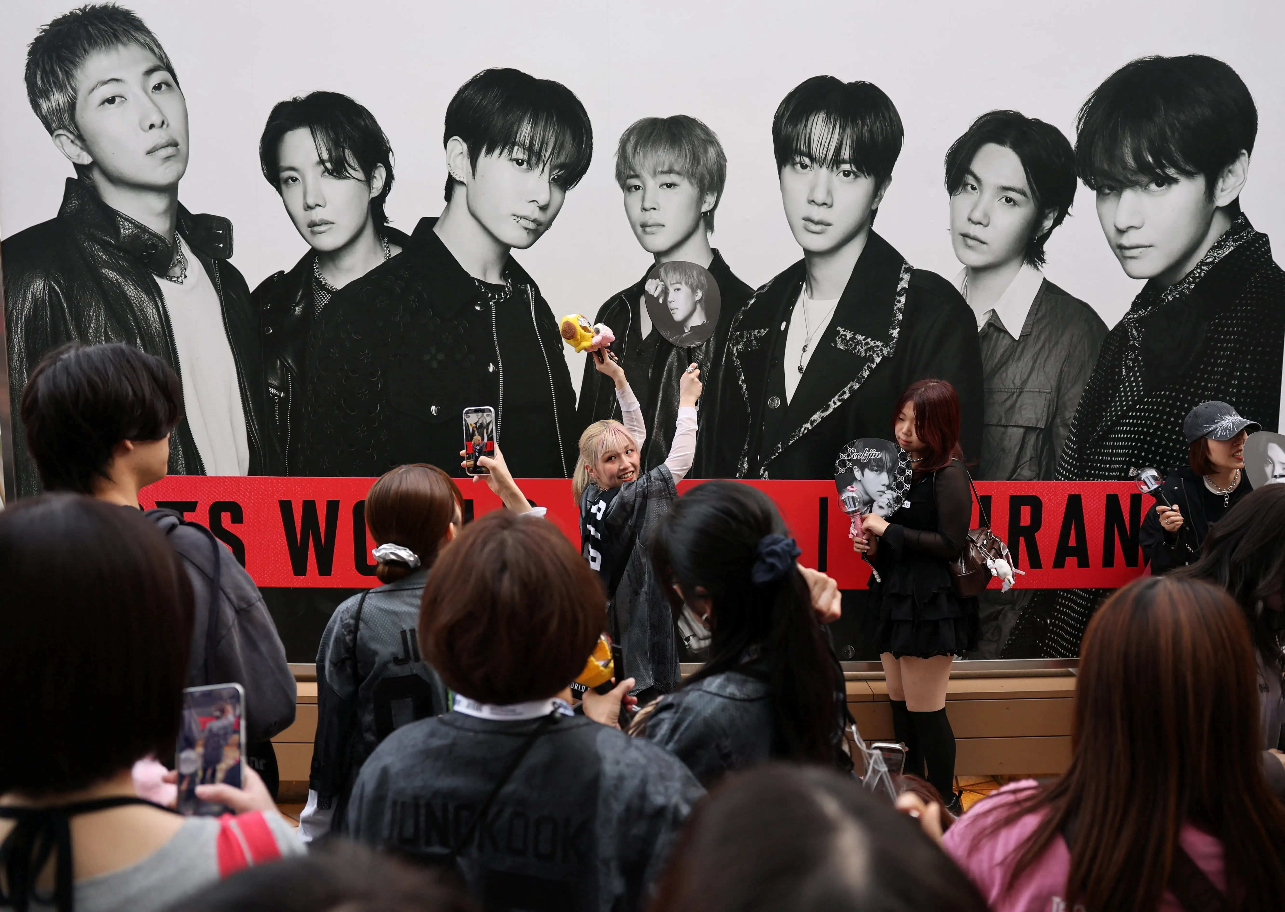 Fans of South Korean K-pop boy band BTS throng around the Tokyo Dome before the start of the band's BTS World Tour 