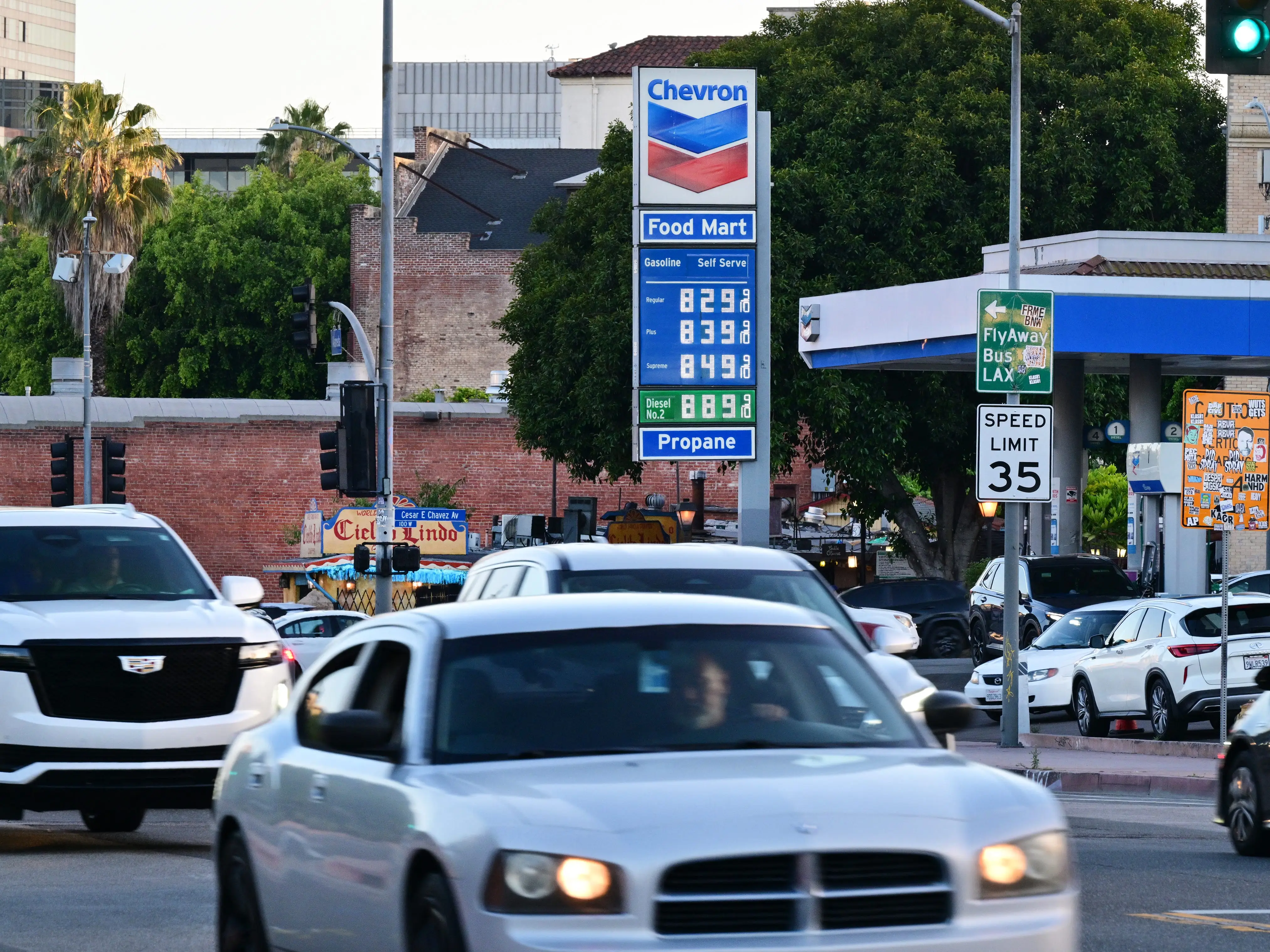 Cars and a Chevron sign with gas prices