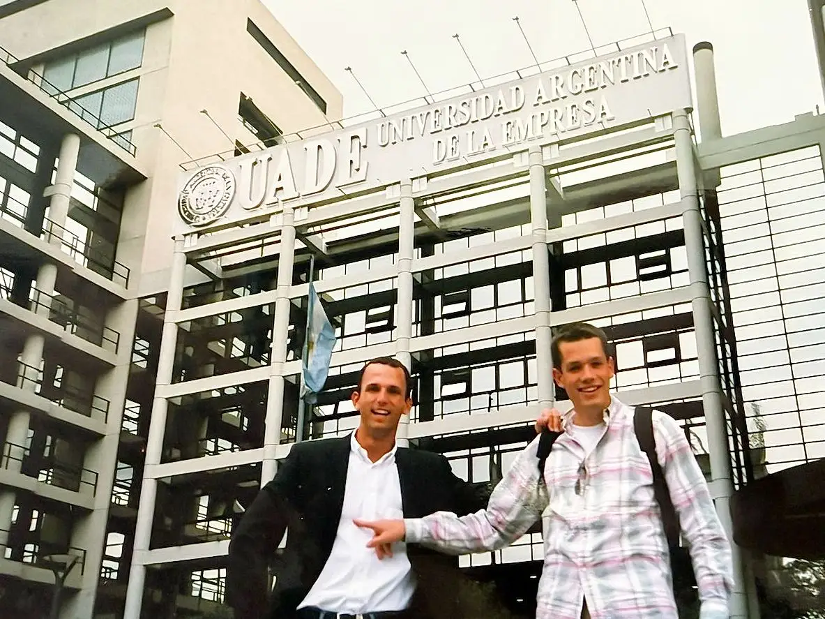 David Von Rosen in front of Universidad Argentina De La Empresa sign