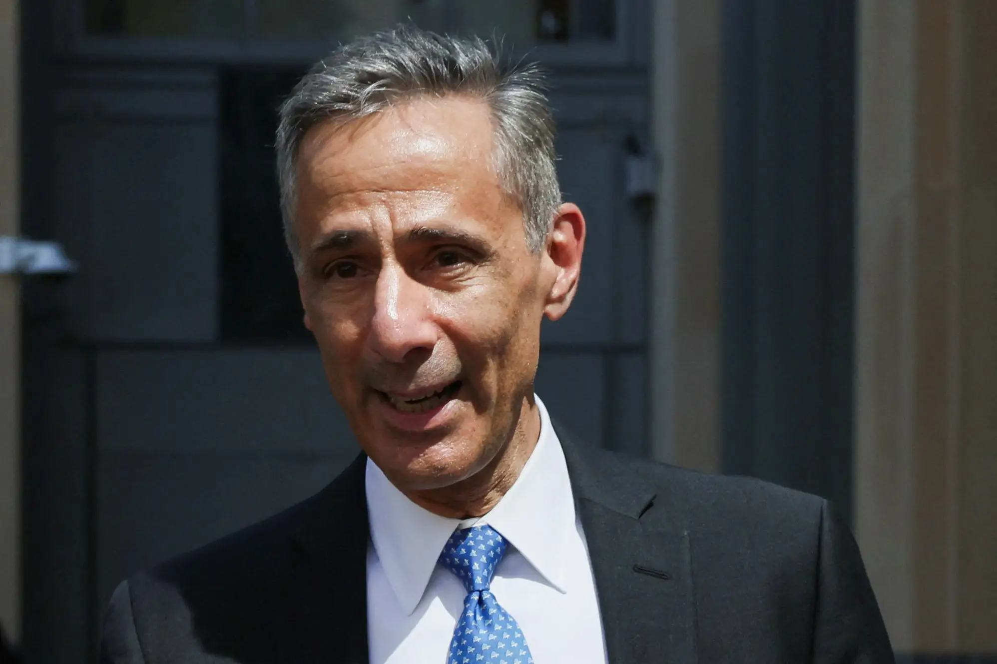 Will Savitt in a suit on the street