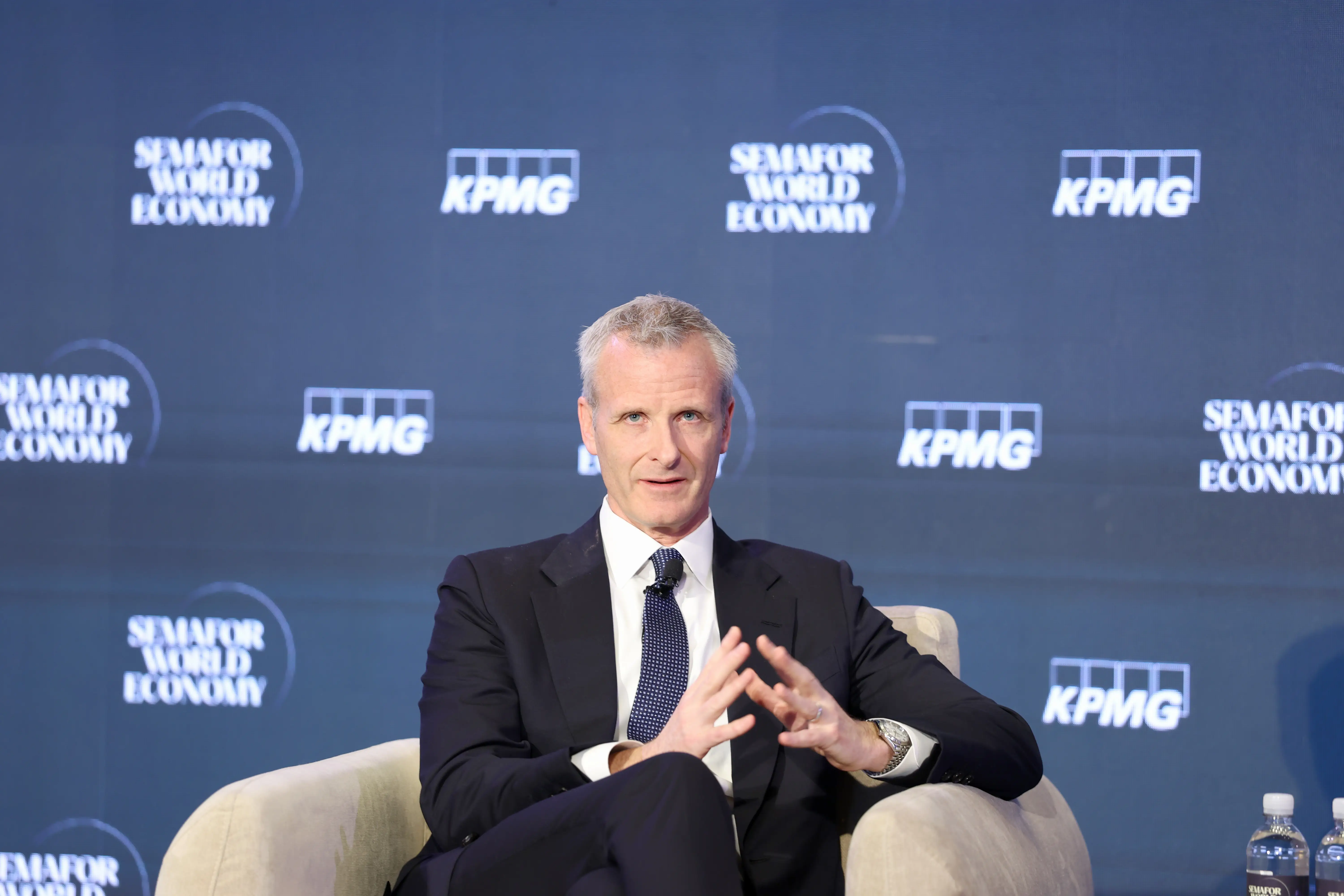 Tim Walsh sits on a stage