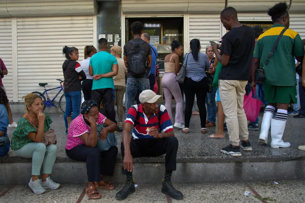 People wait their turn to enter a bank in Havana, Cuba, Wednesday, April 1, 2026.