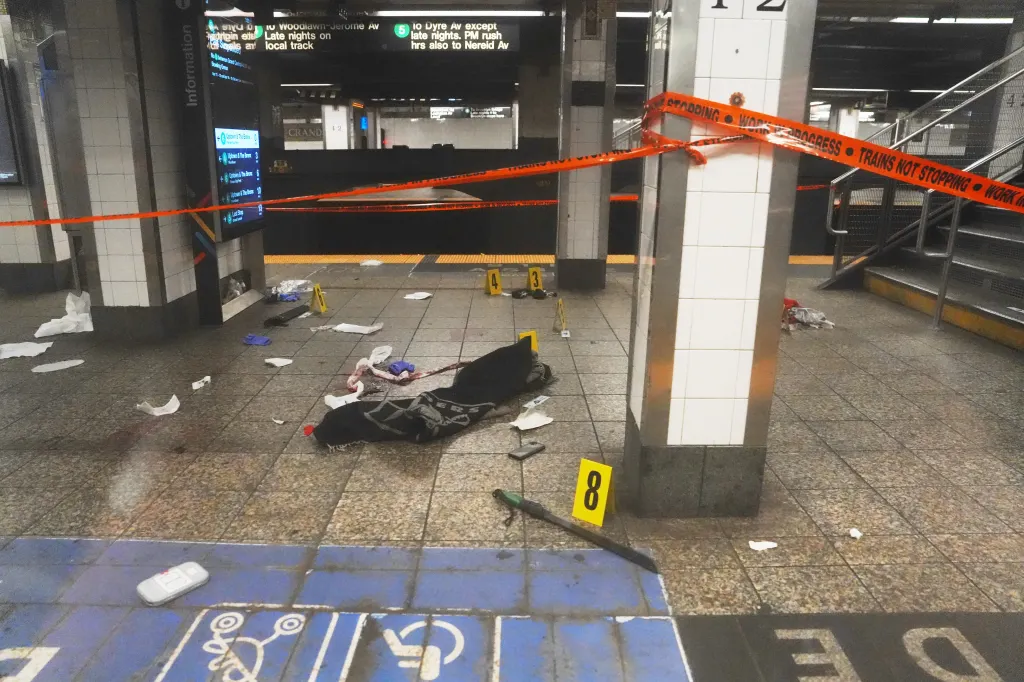 A New York subway platform with crime scene tape reading