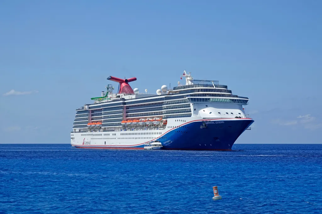 The Carnival Legend cruise ship on blue water in the Caribbean.