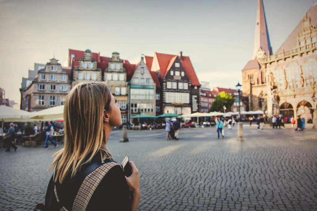 Young lady on medieval street of Bremen, Germany.