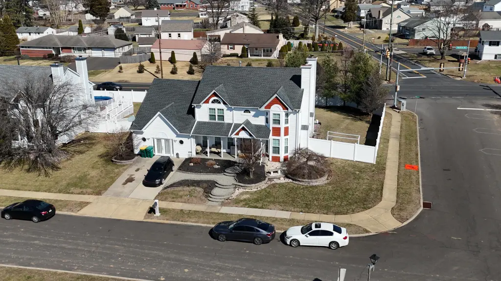 Aerial view of a suburban house and neighborhood.