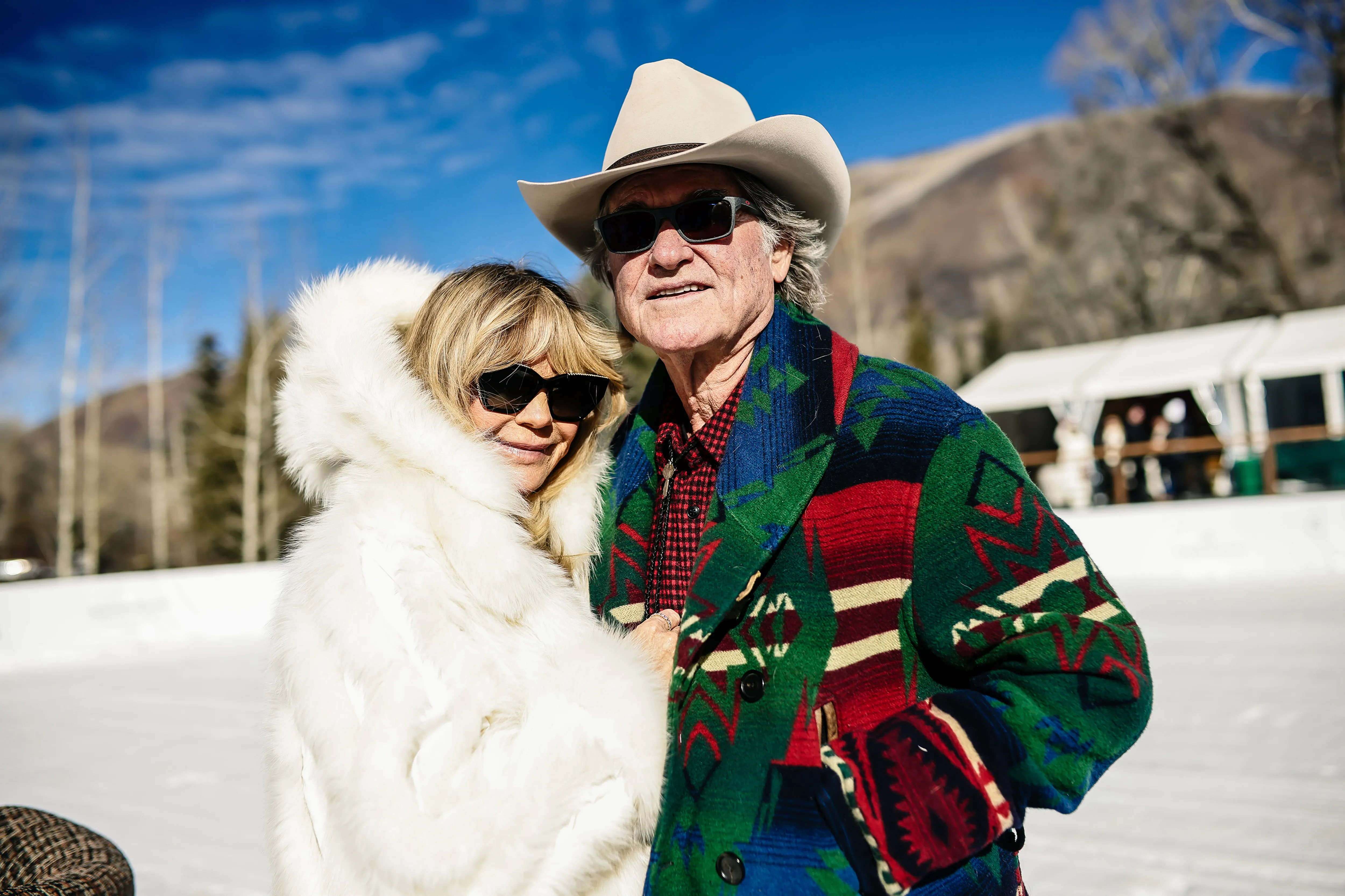 Two well-dressed spectators at The St. Regis World Snow Polo Championships 2025.