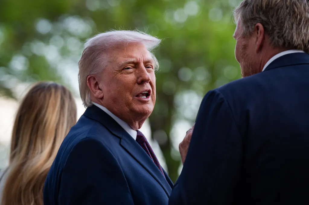 President Trump speaking to King Willem-Alexander of the Netherlands, with First Lady Melania Trump visible in the background.