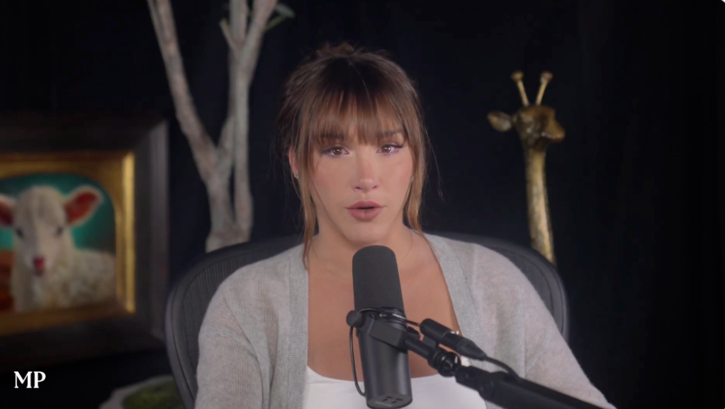 Mikhaila Peterson speaking into a microphone.