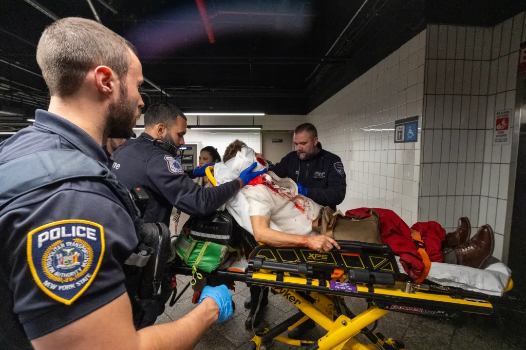 Emergency medical personnel attending to a patient on a stretcher.