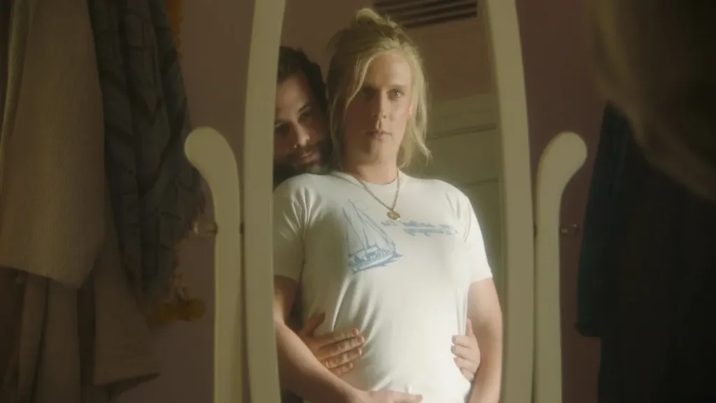 John Early and Eric Rahill embracing in front of a mirror in a still from Maddie's Secret.