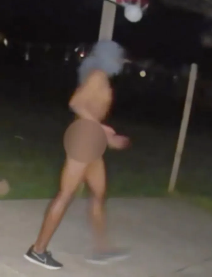 A person running, censored for nudity.