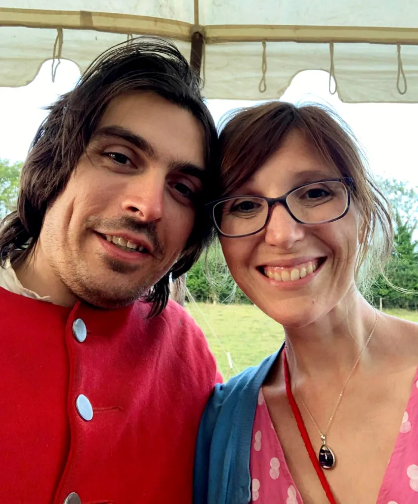 A man and woman smiling for a selfie.