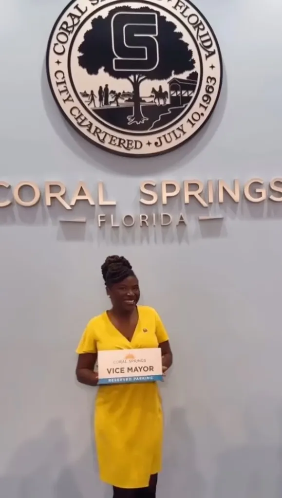 A woman in a yellow dress holding a sign that says 
