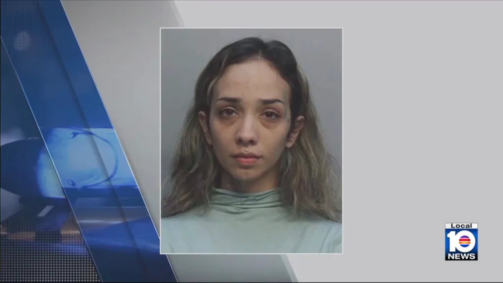 Mugshot of a woman with long hair, dark circles under her eyes, and a piercing above her lip.