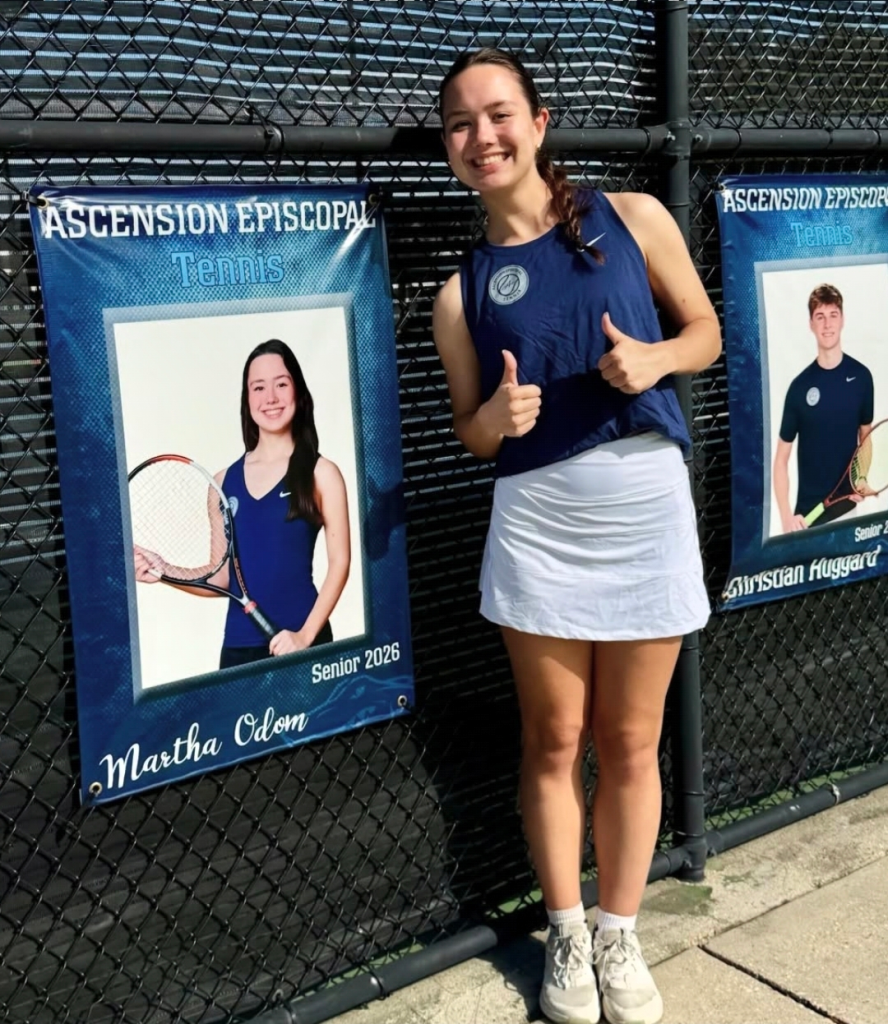 Martha Odom poses with a senior portrait of herself for Ascension Episcopal tennis.