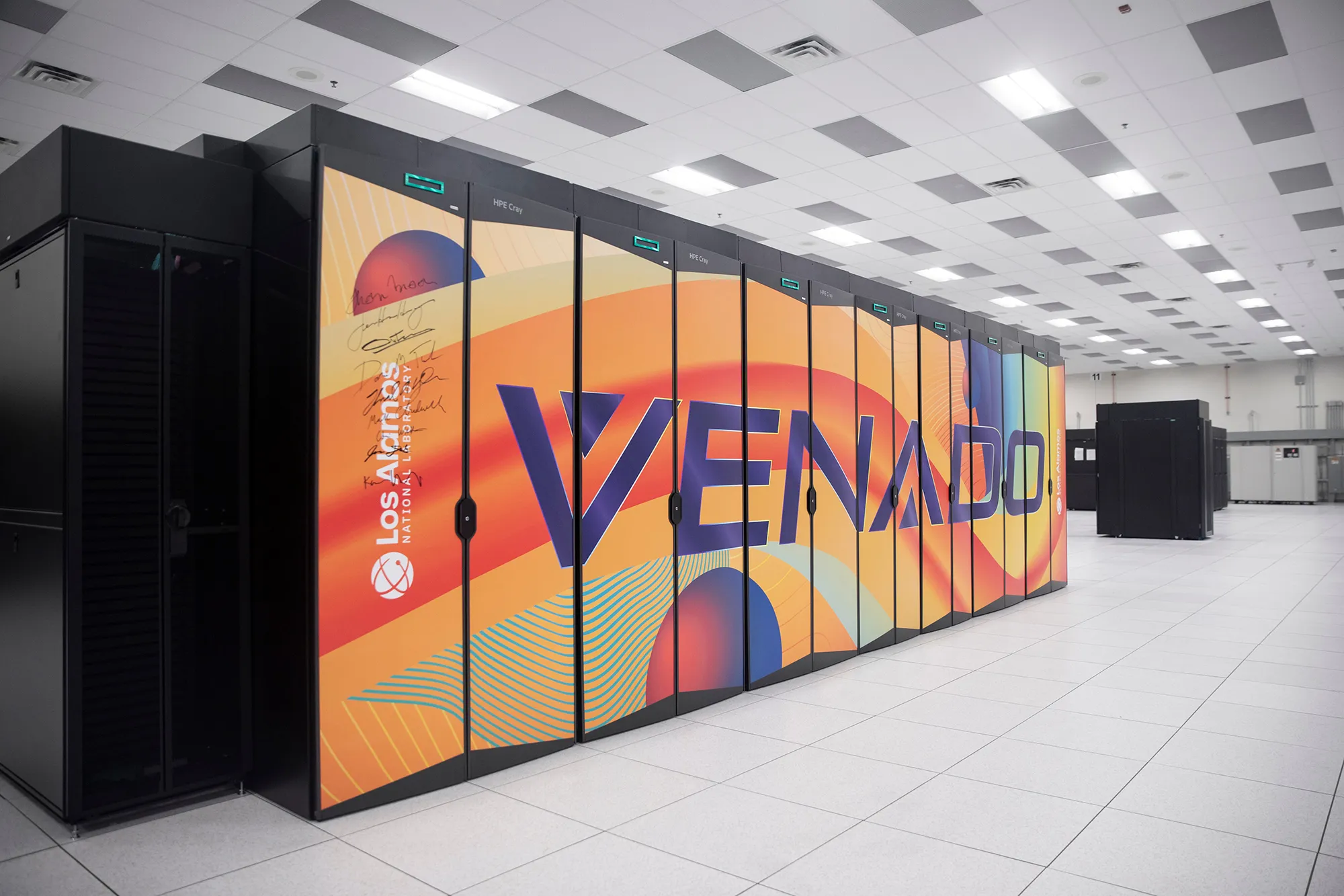 a supercomputer with a brightly-colored exterior that reads “Venado.” The surrounding area looks like a typical office setting