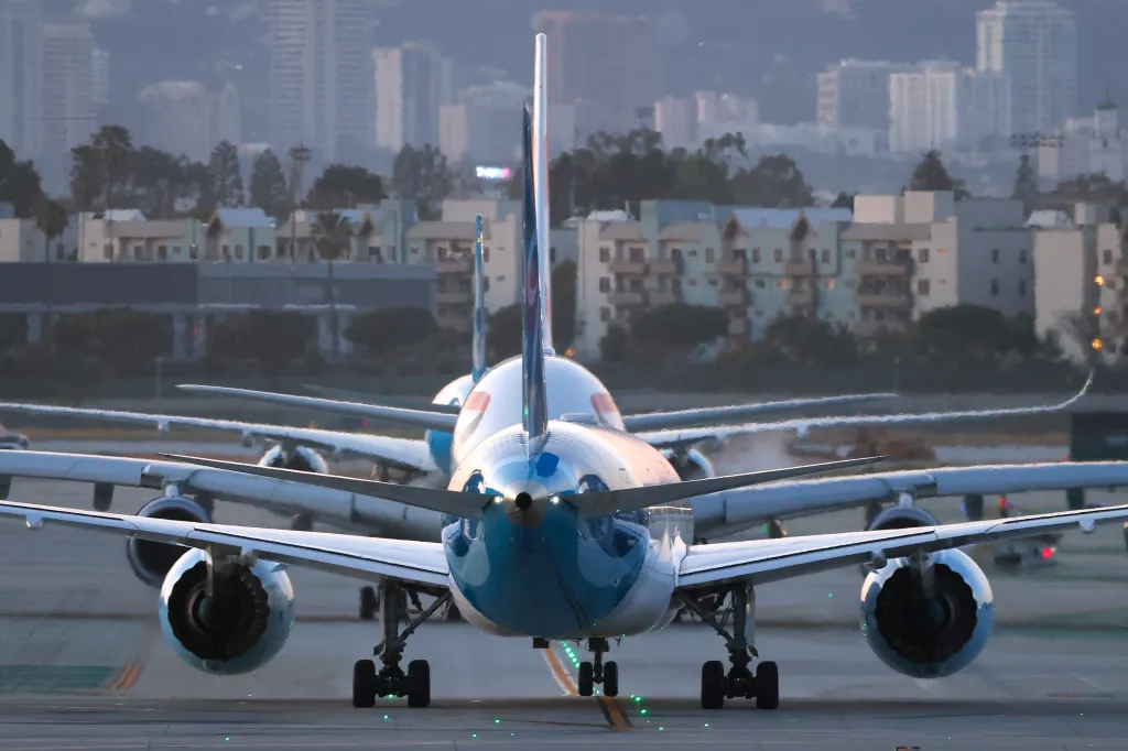 Norse Boeing 787-9 Dreamliner and British Airways Airbus A380-841 aircraft taxiing on the runway at Los Angeles International Airport.
