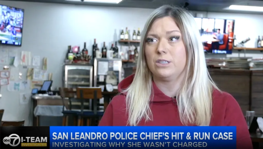 A woman with long blonde hair and a red sweatshirt is interviewed by ABC7 Eyewitness News I-Team about the San Leandro Police Chief's hit and run case.