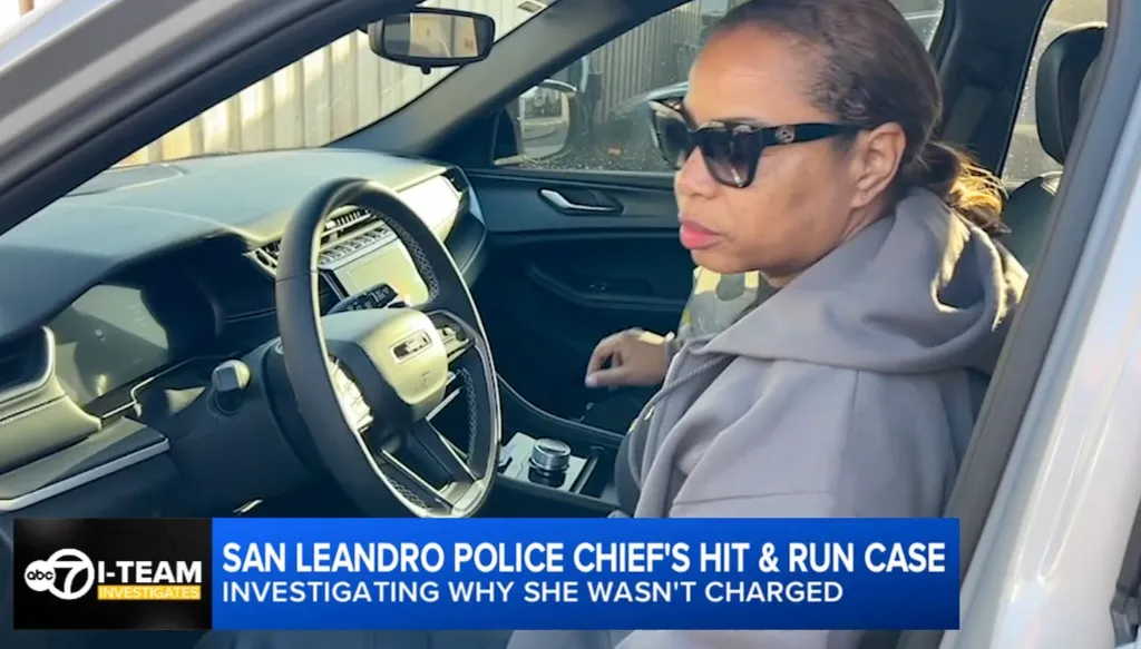 Angela Averiett, San Leandro Police Chief, wearing sunglasses, in an unmarked car.