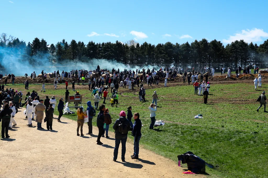 Activists attempting to enter the Ridglan Farms beagle breeding facility, with smoke in the background.