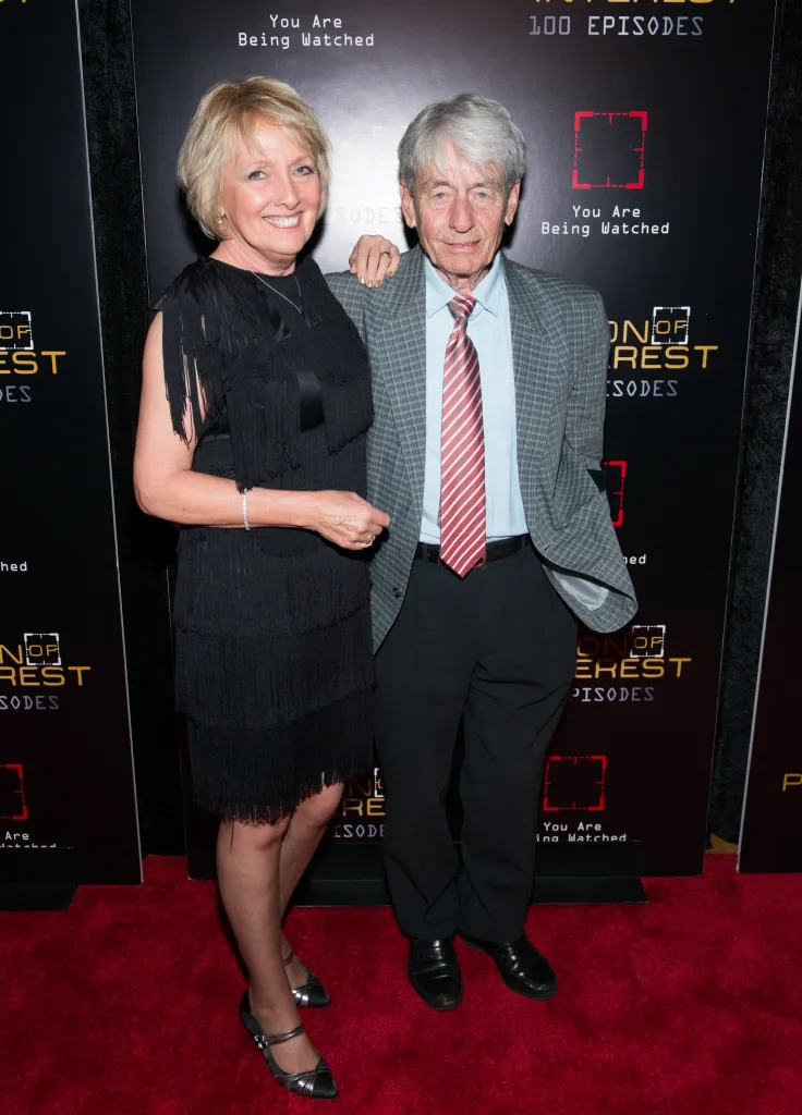 Actors Kim Hartman and John Nolan posing on a red carpet.
