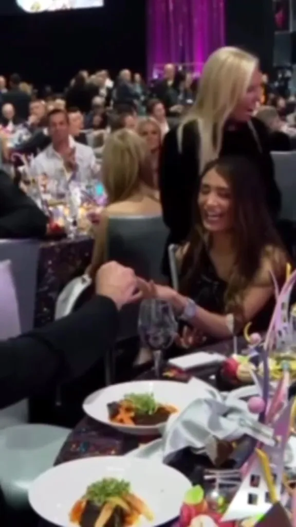 Adva Lavie smiling as a man puts an engagement ring on her finger.