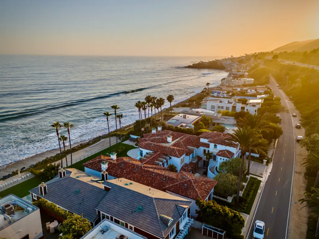 Aerial view of the Pacific Coast Highway in Malibu at sunset.