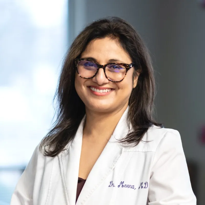 Dr. Meena smiling.