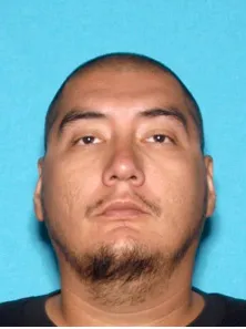 Refugio Aldama Jr., a missing person, in a headshot against a blue background.